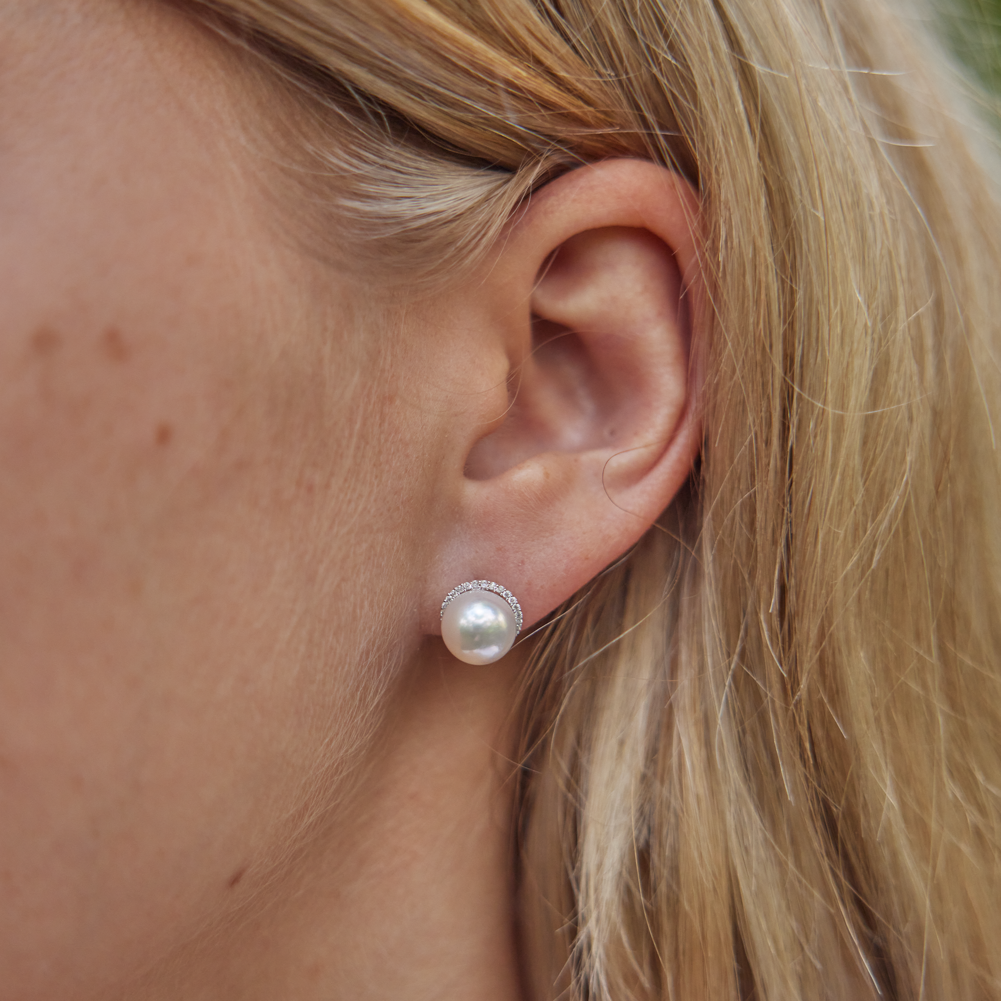 Close up of ear wearing Halo Akoya White Pearl Earrings in White Gold with Diamonds - 8-8.5mm