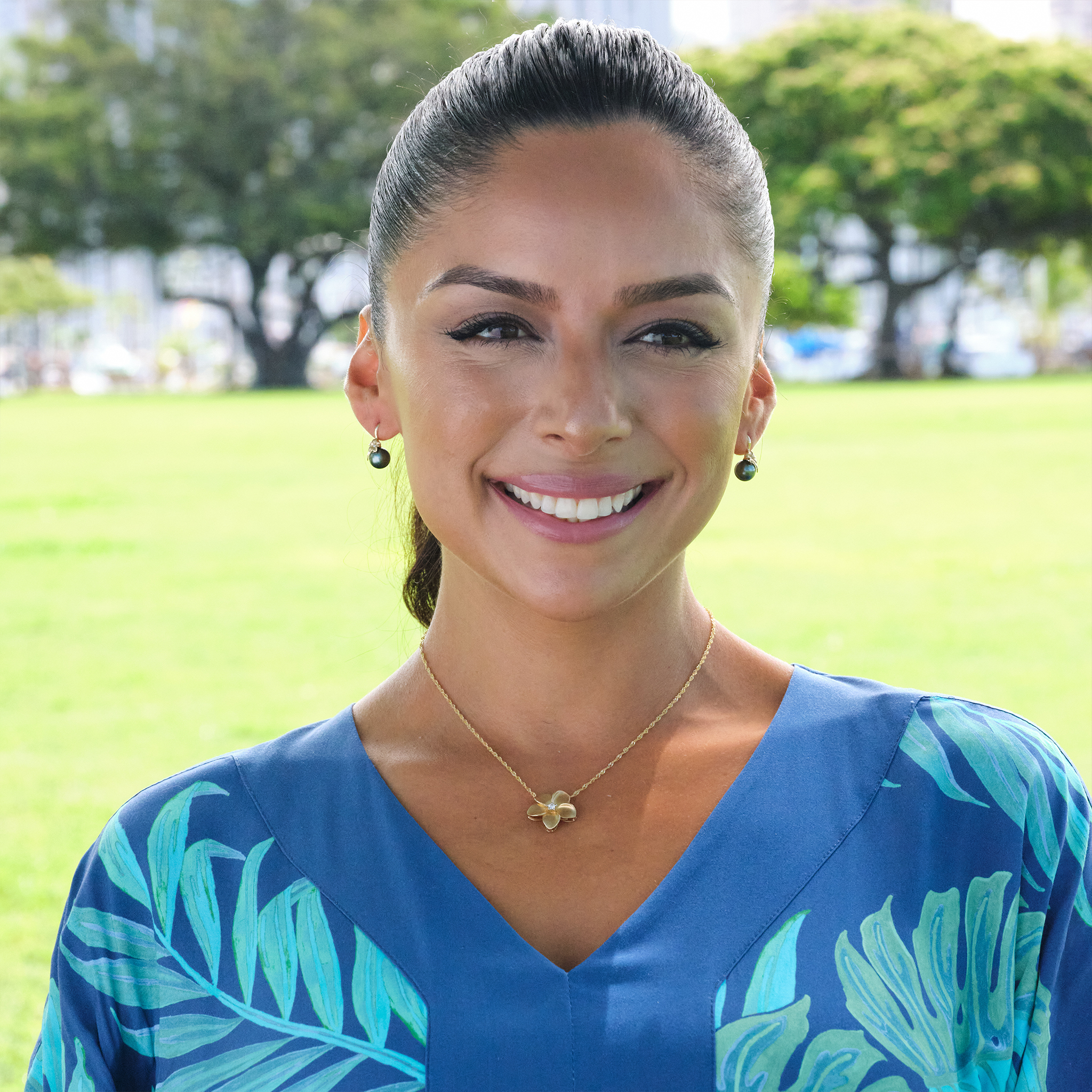 A woman wearing Plumeria Tahitian Black Pearl Earrings in Gold with Diamonds - 8-9 - Maui Divers Jewelry