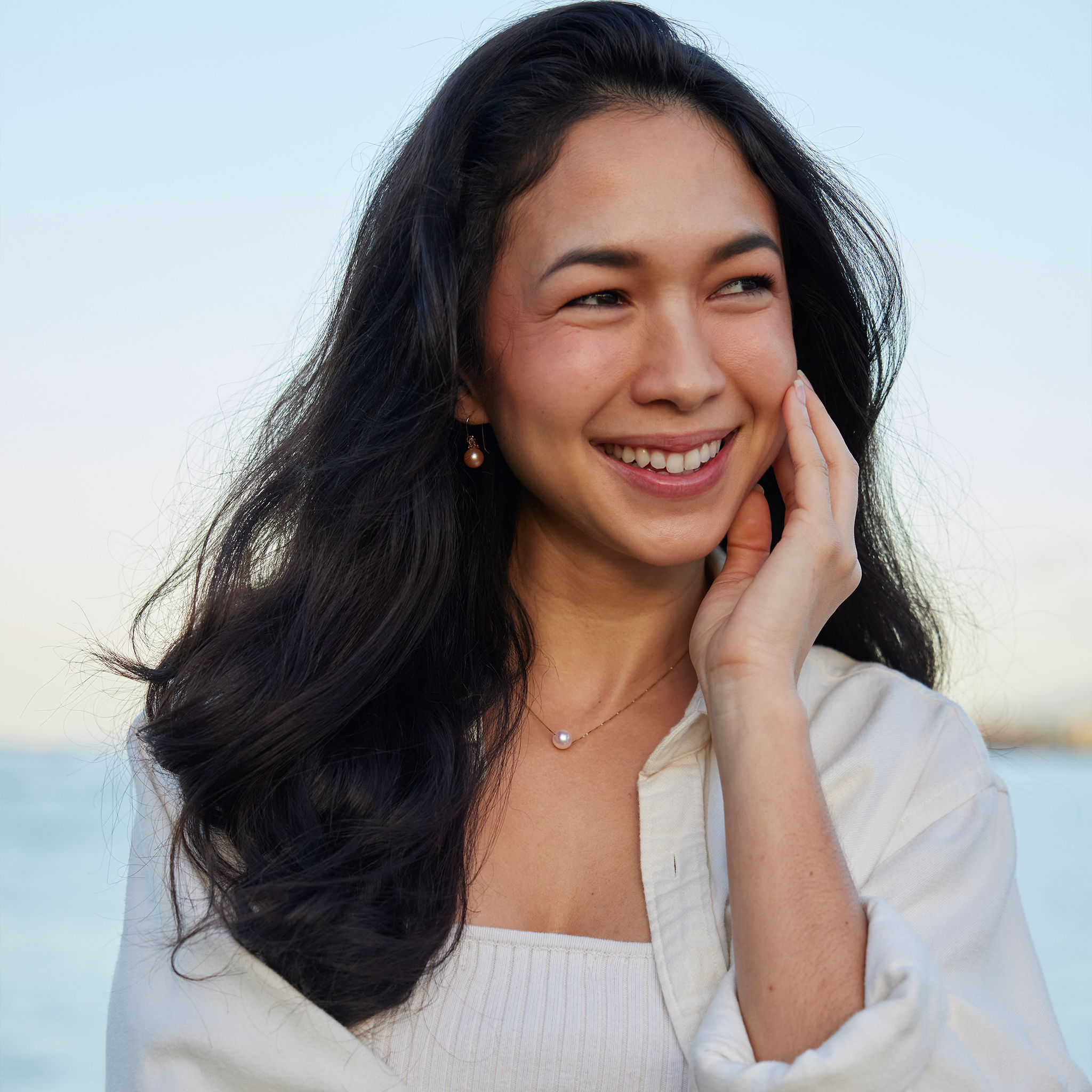 Smiling Woman wearing Peach Freshwater Pearl Earrings in Rose Gold with Diamonds - 9-10mm