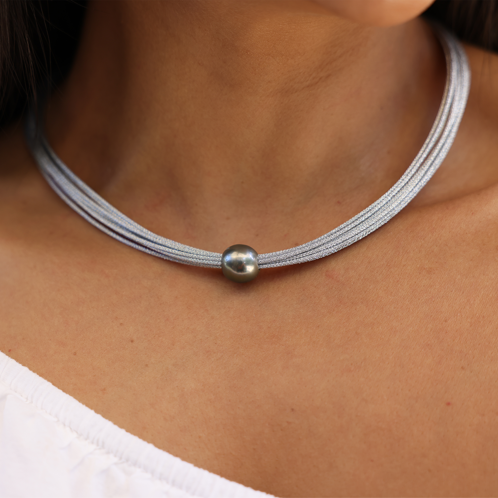 Woman wearing 18" Tahitian Black Pearl Necklace in Stainless Steel - 12-14mm by Maui divers Jewelry