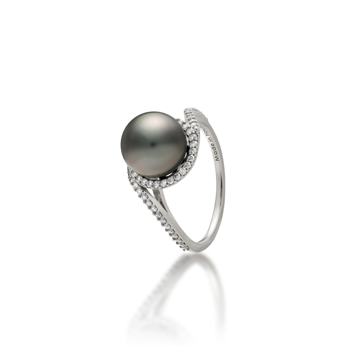 A 14k white gold ring with a páve diamond band that curves to the top to form a diamond halo around a Tahitian black pearl, shown on a white background