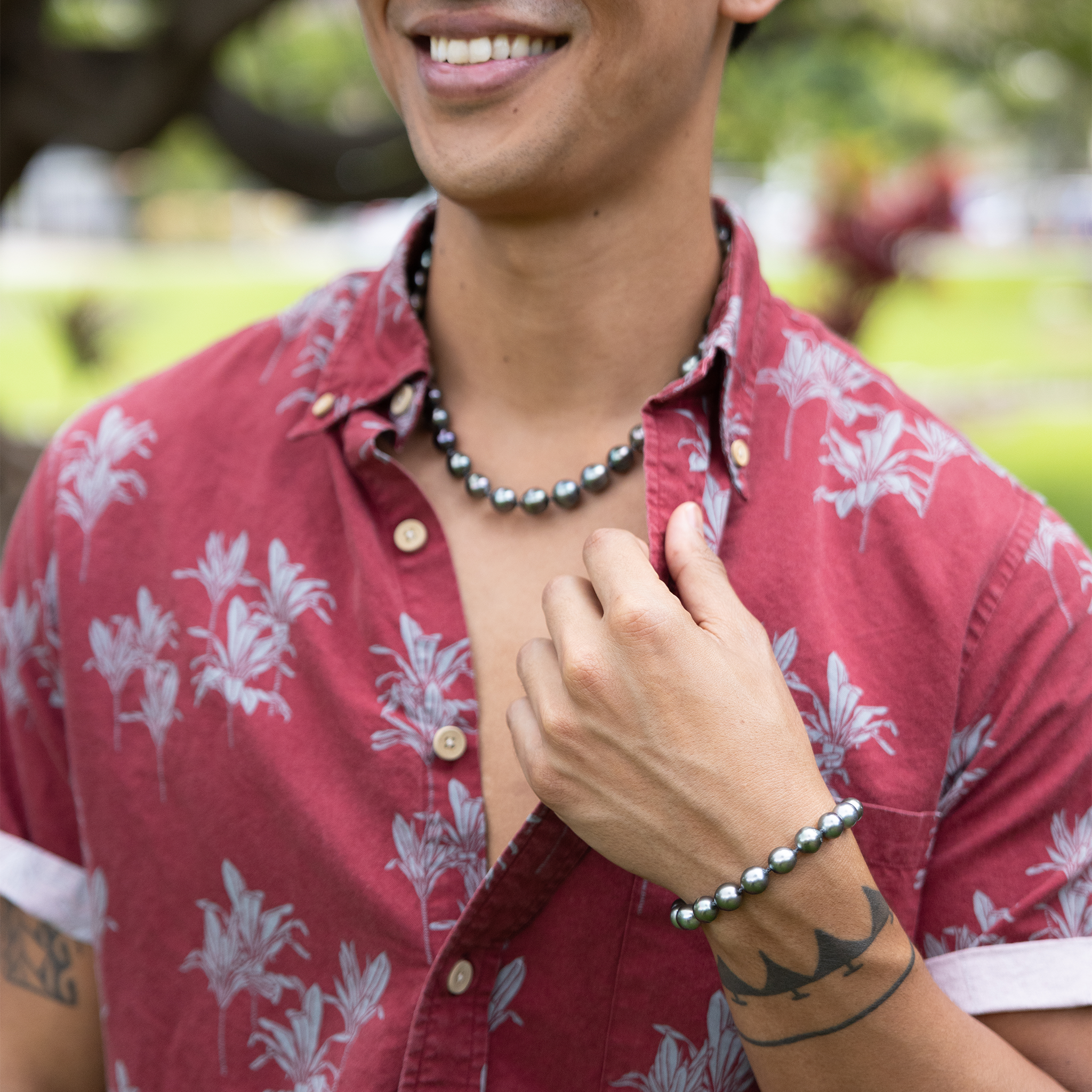 Man wearing an adjustable 8-10mm Tahitian Black Pearl Bracelet in Gold and Tahitian Black Pearl Strand