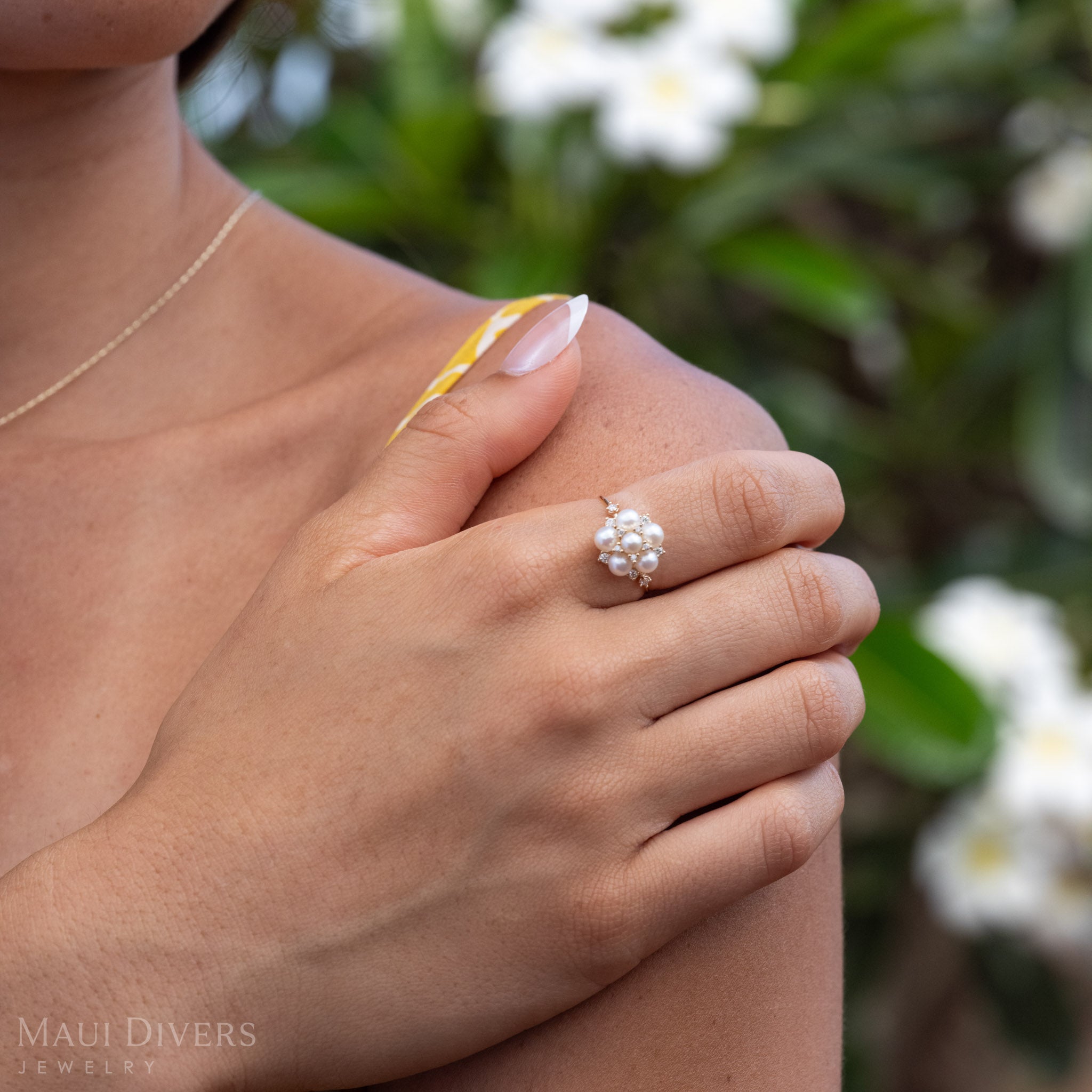 Close up of Tiny Natural White Freshwater Pearls on a 14k Gold Ring with Diamonds.
