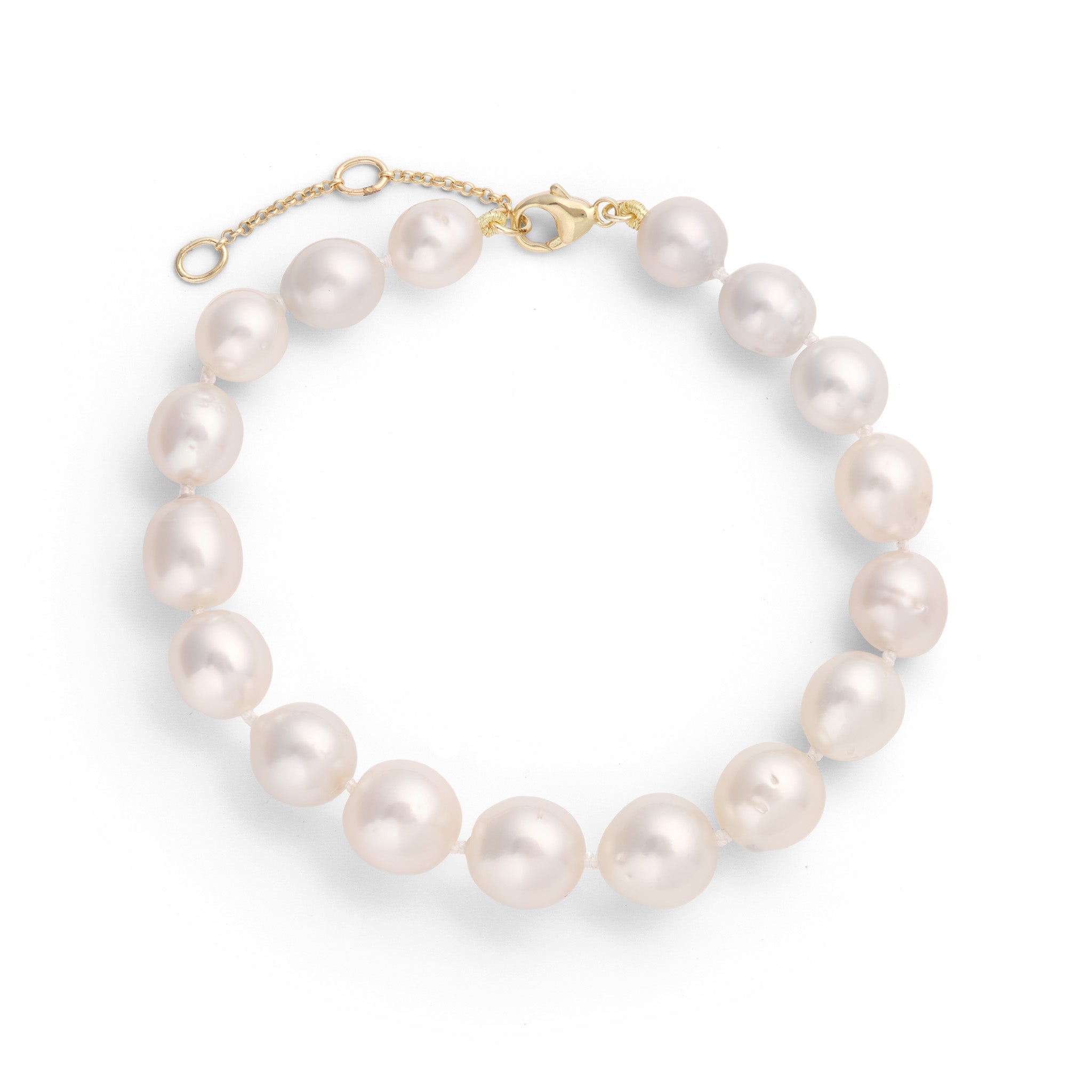 Top down view of a South Sea Silver and White Pearl Bracelet with an adjustable gold clasp.