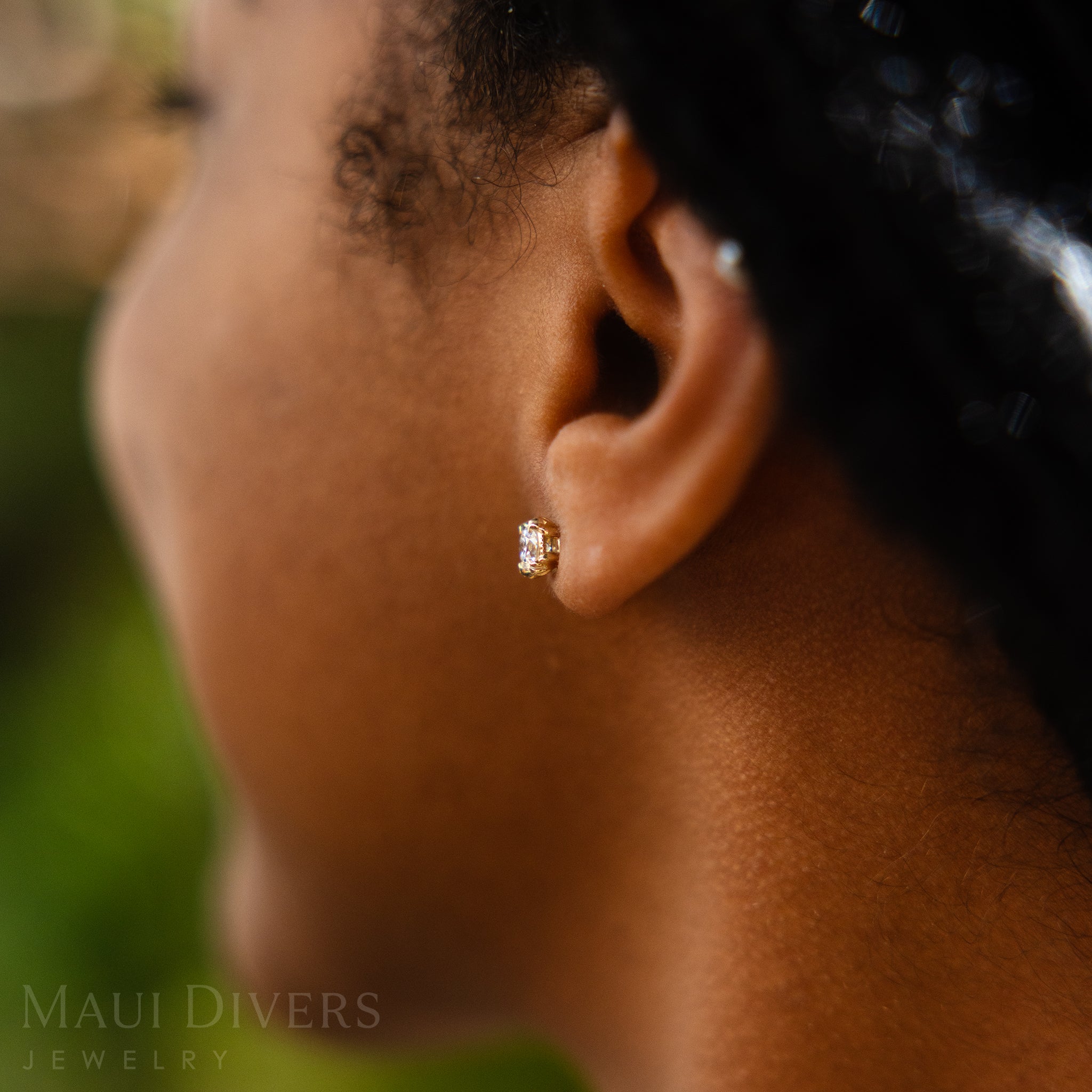 Close-up of an ear wearing Hidden Hawaiʻi Maile Earrings in 14k Yellow Gold with Lab Grown Diamonds