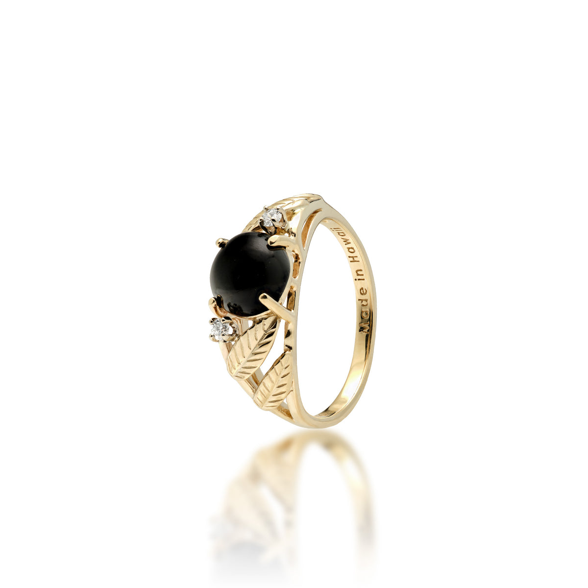 A 14k yellow gold ring with a round 7mm Hawaiian black coral gem at the crown, a diamond on each side, and diamond-cut maile leaves along the sides of the band, shown on a white background