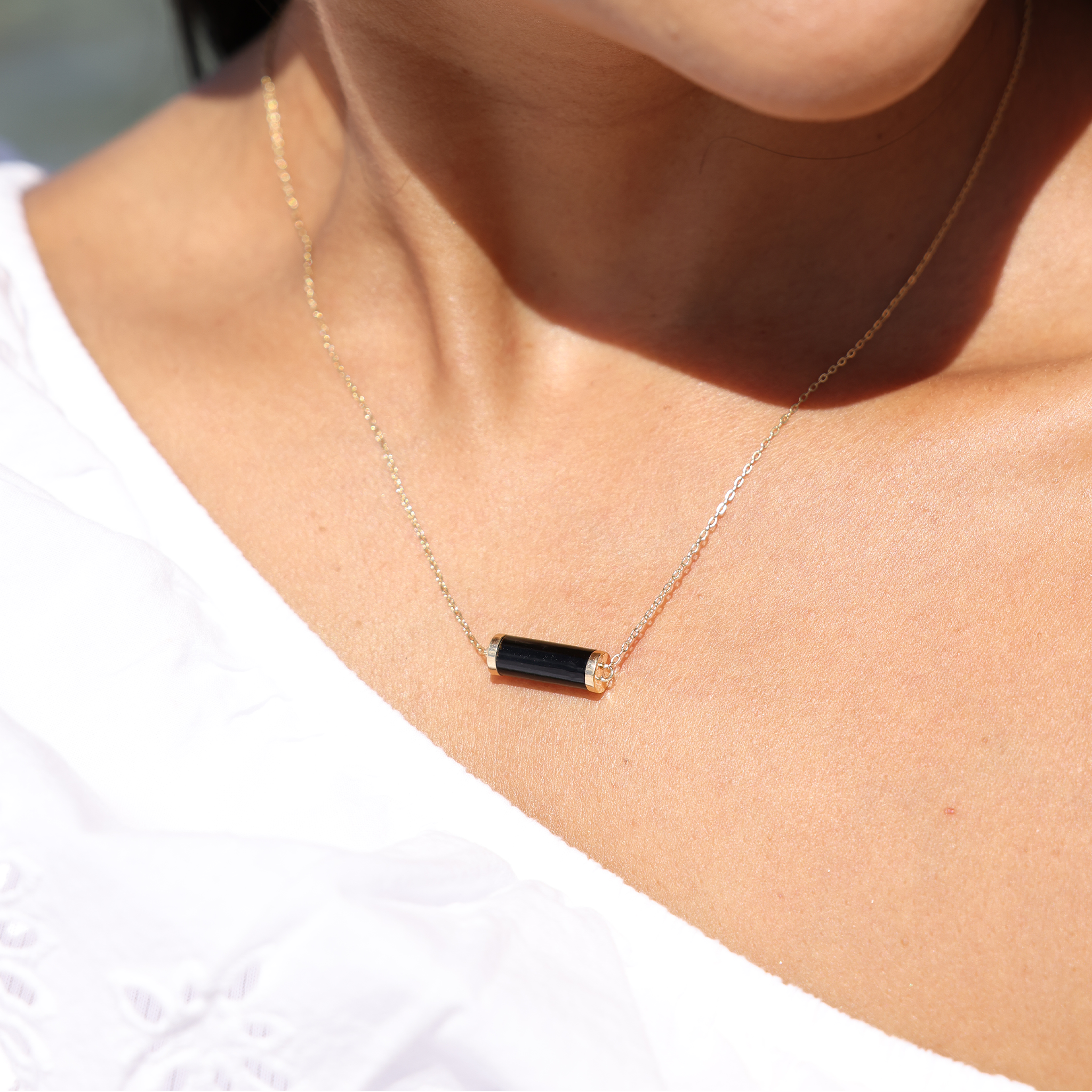 A woman wearing an Adjustable Ocean Chimes Black Coral Necklace in Gold - Maui Divers Jewelry