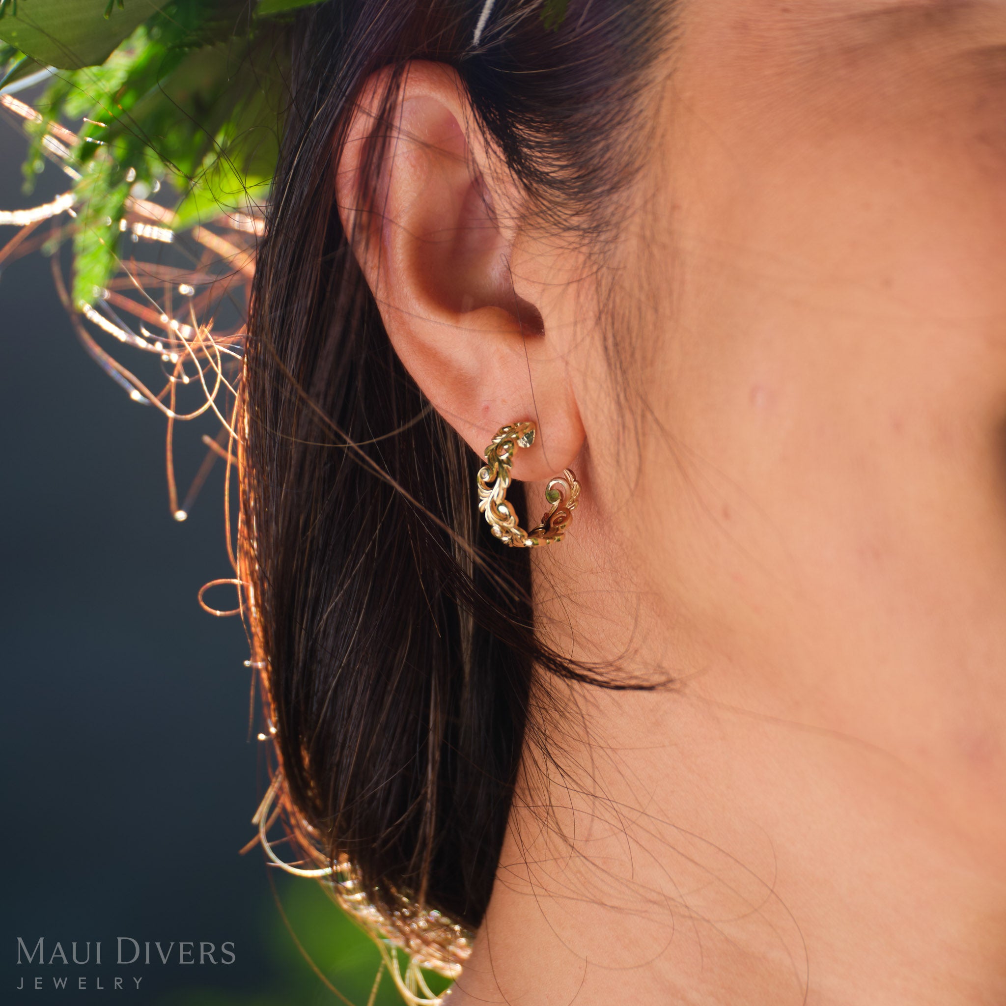 Close-up of a Living Heirloom hoop earring with diamonds in 14k yellow gold worn on an ear