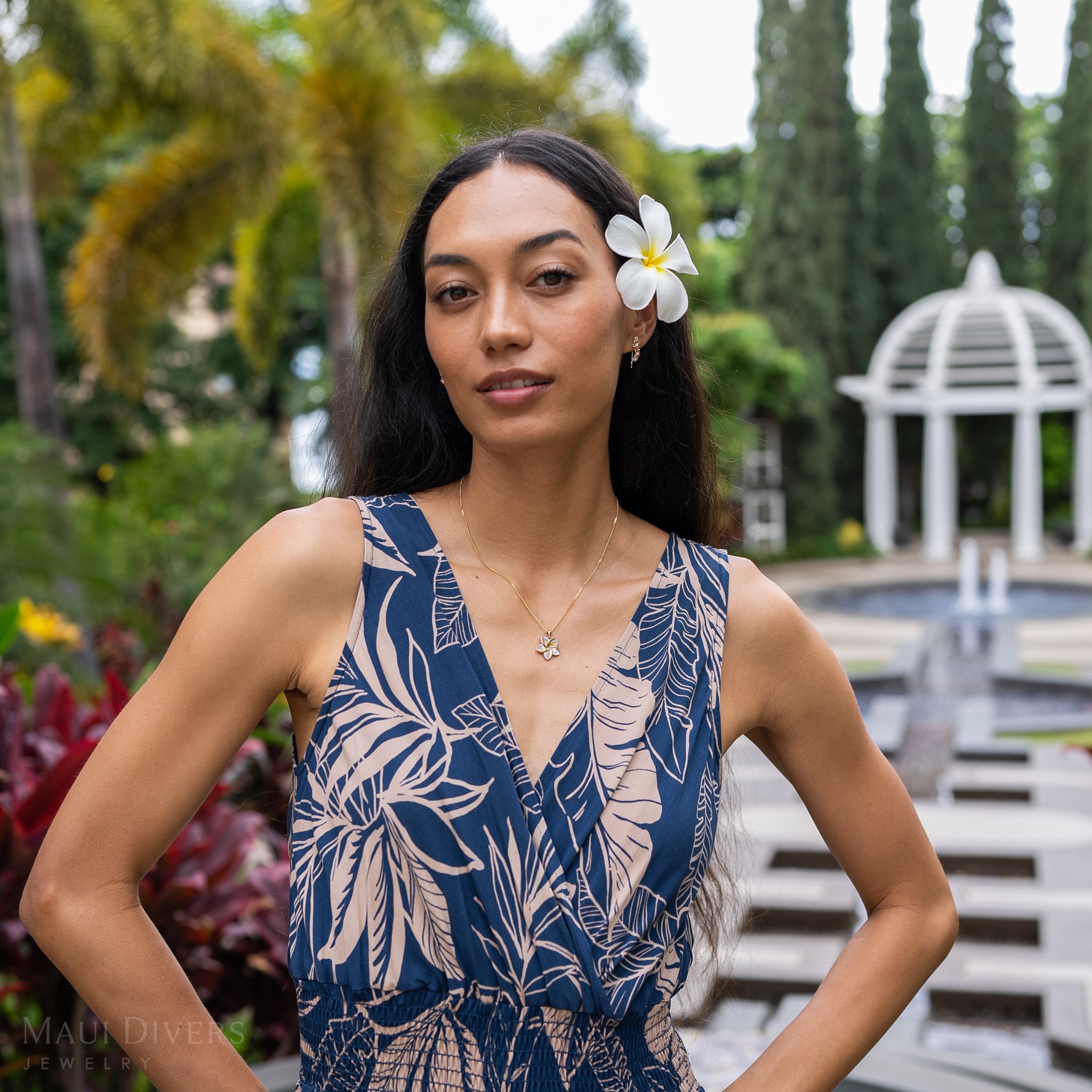 Woman at resort wearing Plumeria Mother of Pearl Pendant in 14k Yellow Gold