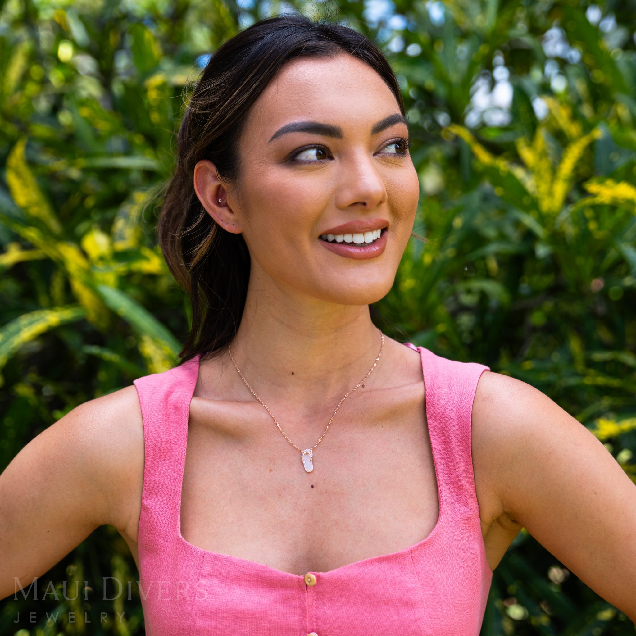 Woman in a garden wearing Pink Mother of Pearl Slipper Pendant with Rose Gold straps