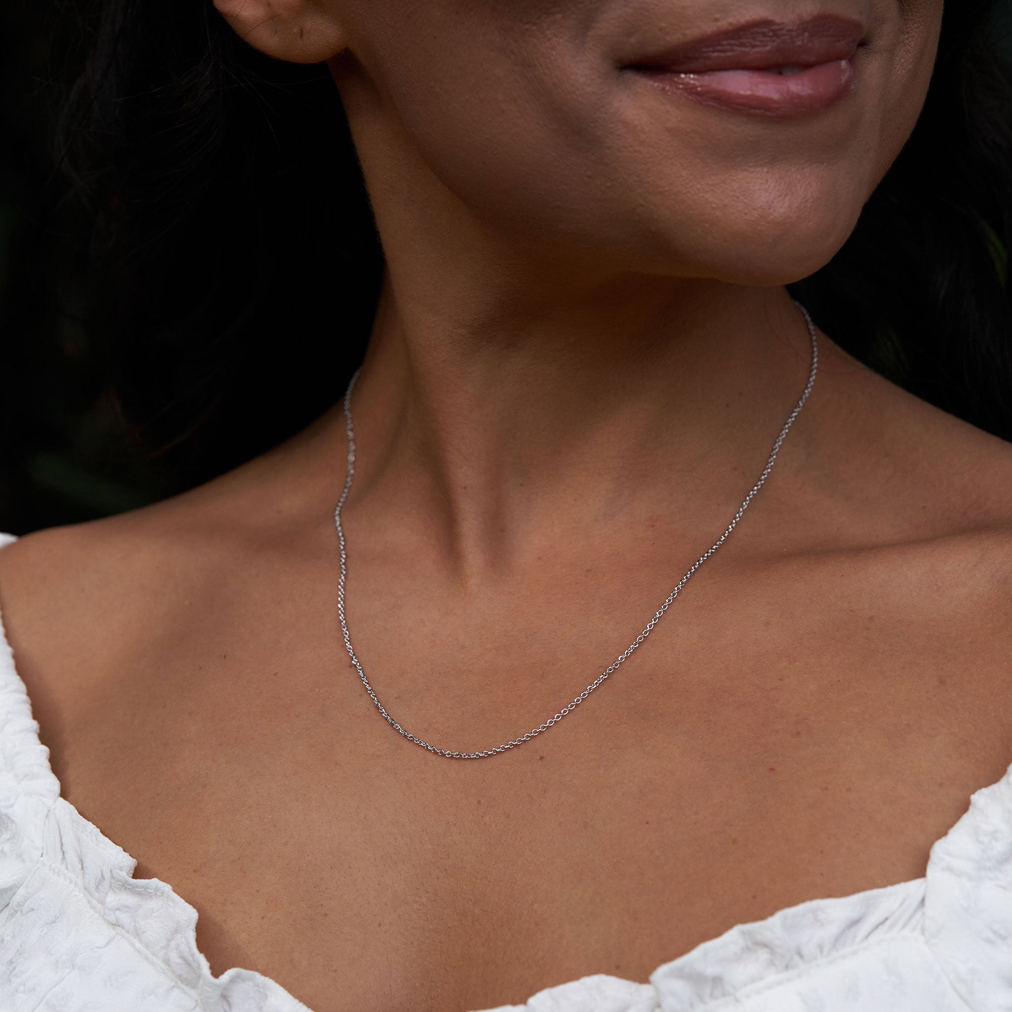 Adjustable 24" 1.0mm Cable Chain in Sterling Silver on a womanʻs chest