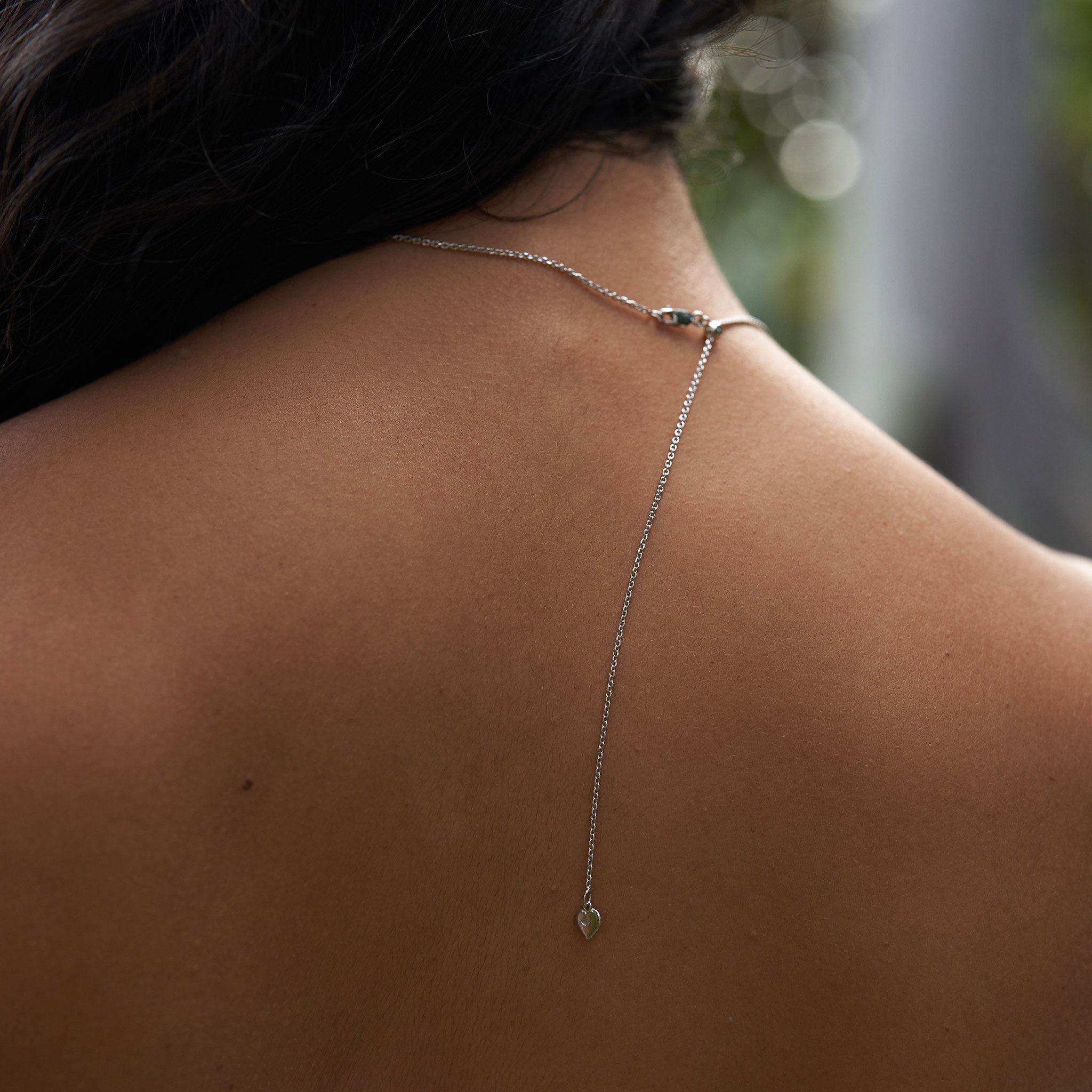 Womanʻs back showing Adjustable detail of the 24" 1.0mm Cable Chain in Sterling Silver