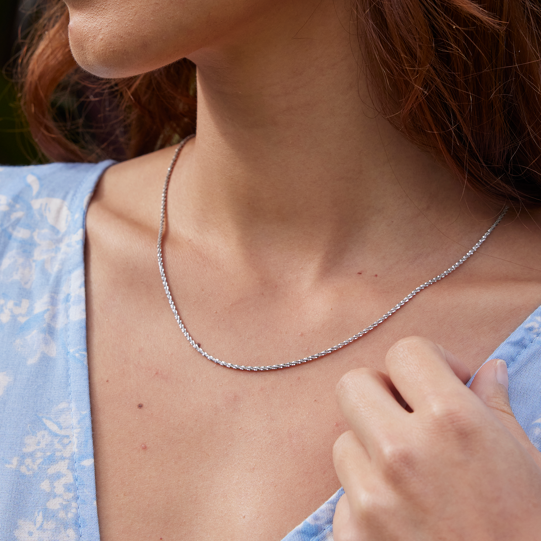 Close up of 24" Adjustable 1.5mm Margarita Chain in Sterling Silver on a womanʻs neck