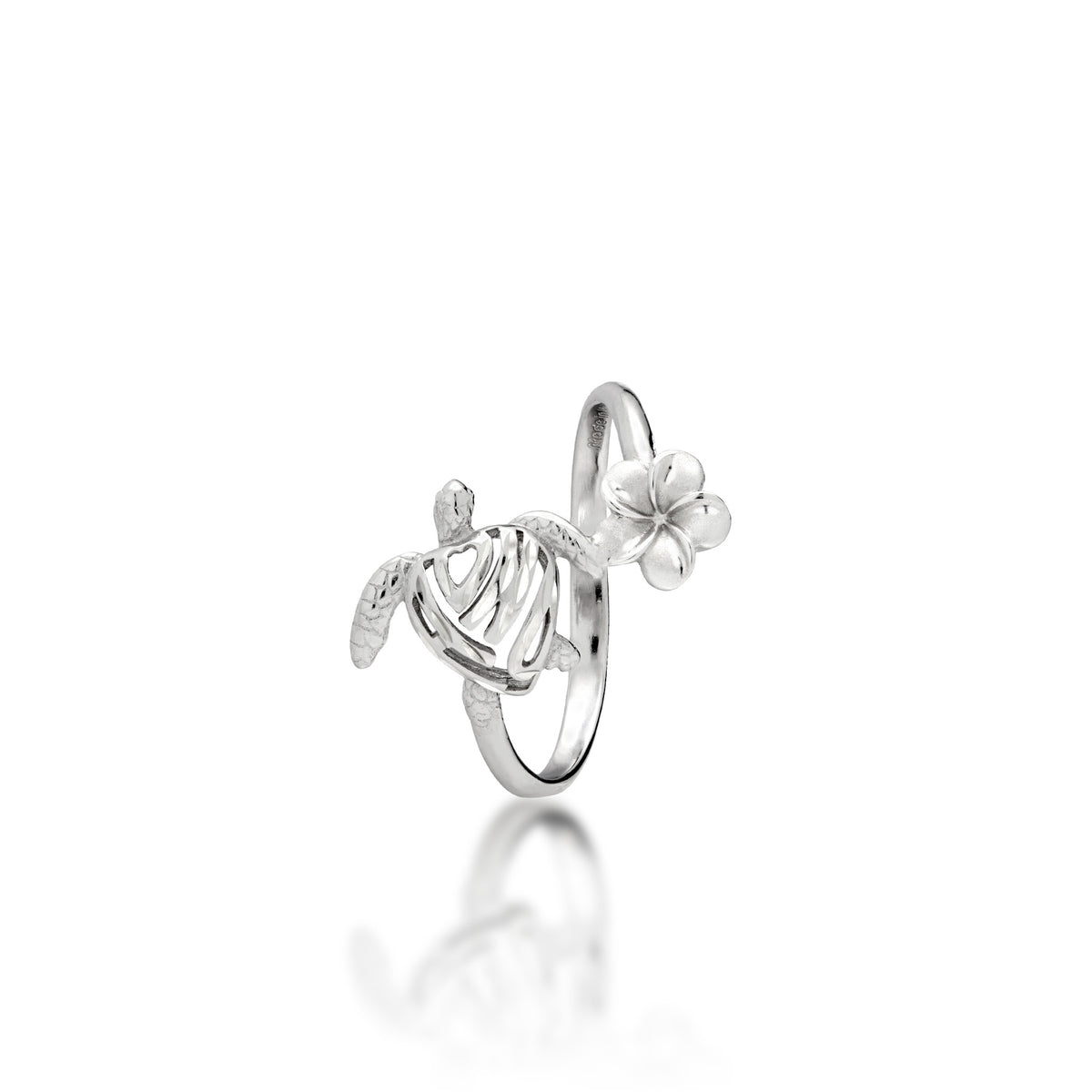 Side view of a sterling silver ring featuring a stylized sea turtle with a heart-shaped shell that has "HONU" cut out in it, a small plumeria flower connecting the turtle to the other side of the band, shown on a clean white background with a soft reflection.