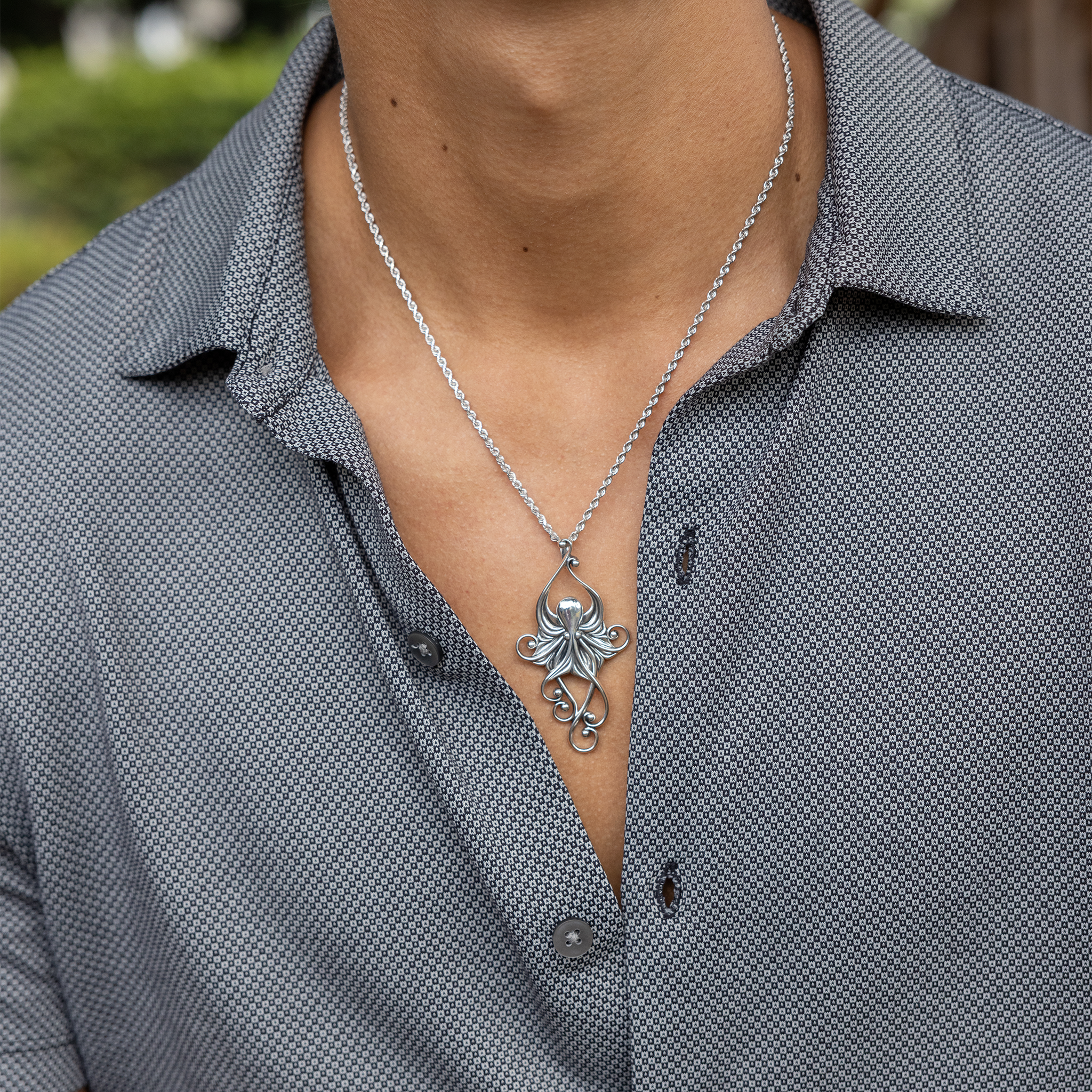 Close up of Living Heirloom Octopus Pendant in Sterling Silver on a man's chest