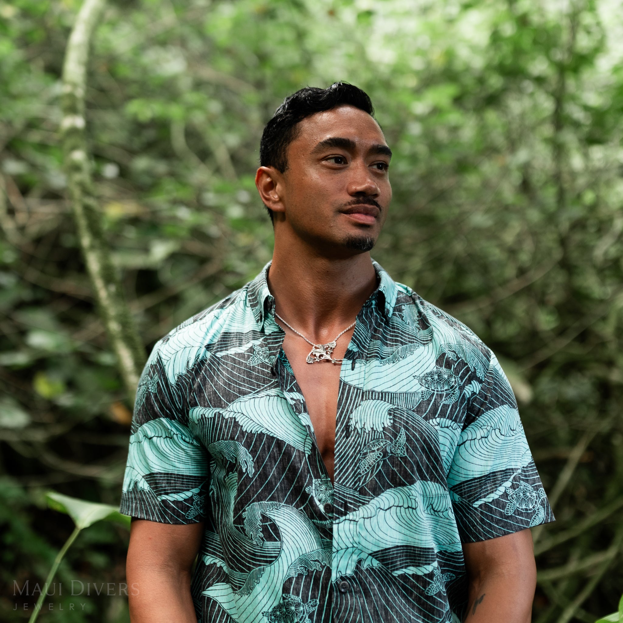 Man in a forest wearing a Living Heirloom Manta Ray Pendant in Sterling Silver