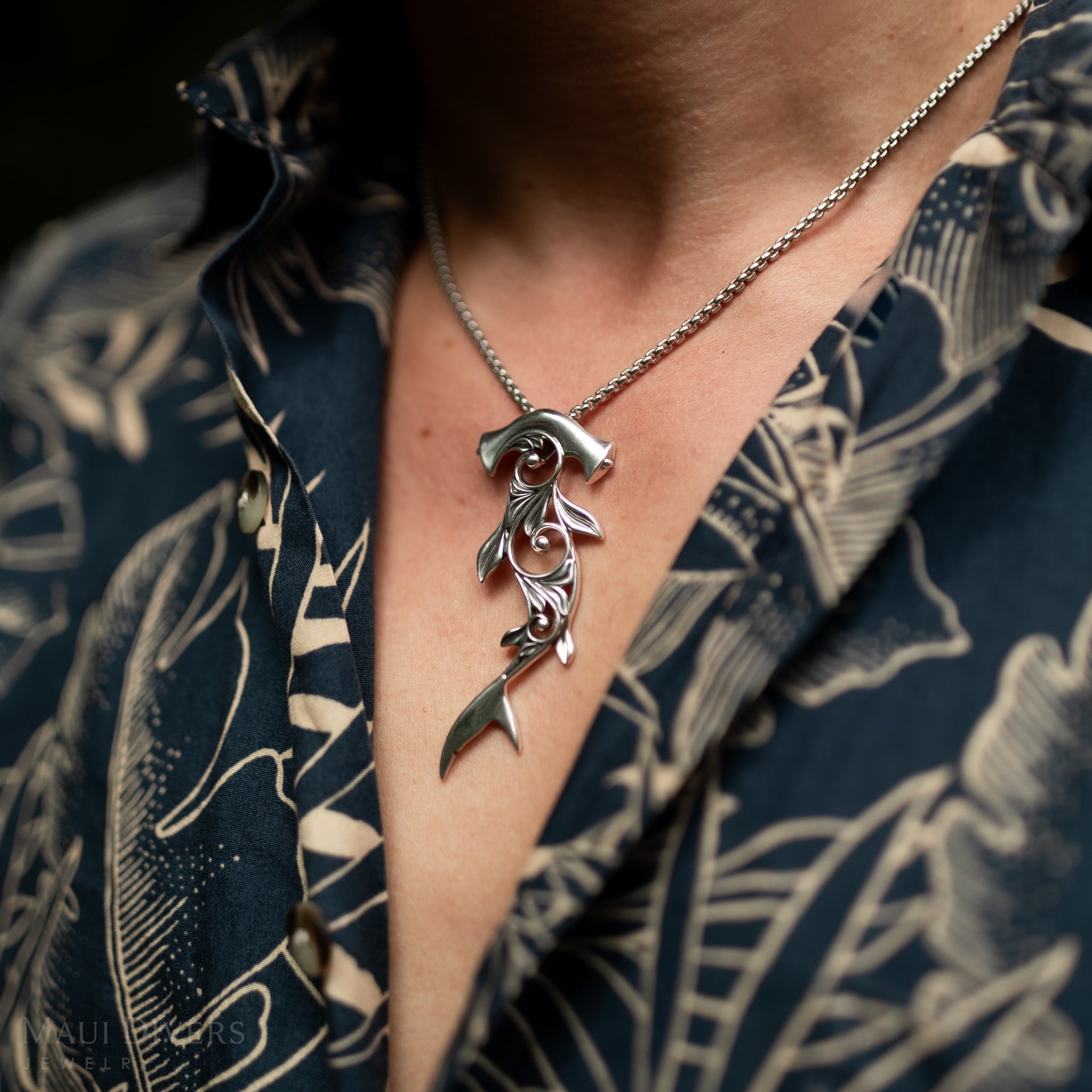 Close up of a Living Heirloom Hammerhead Shark Pendant in Sterling Silver on a person's chest