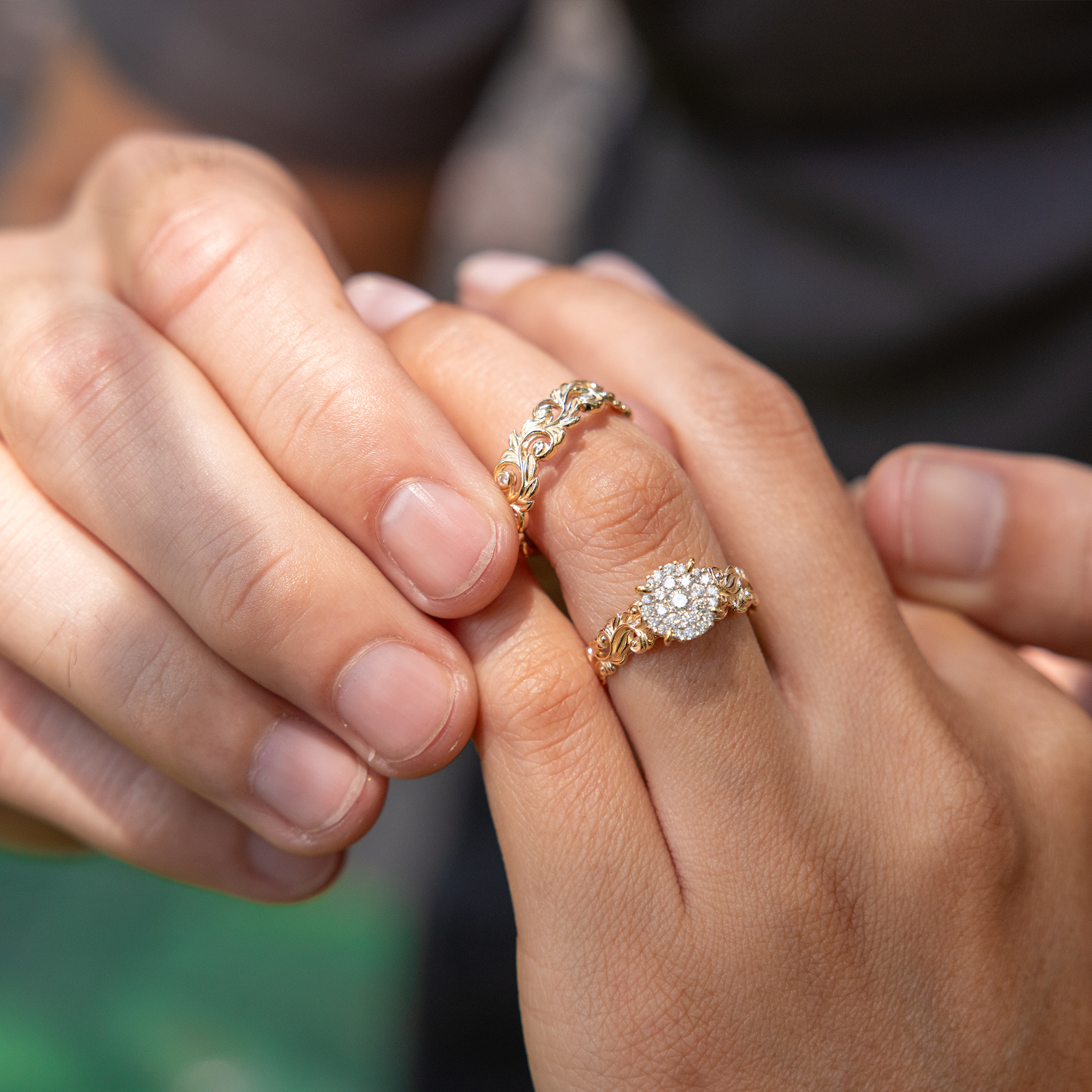 Hand placing Living Heirloom Ring in 14k Yellow Gold with Diamonds on the other hand