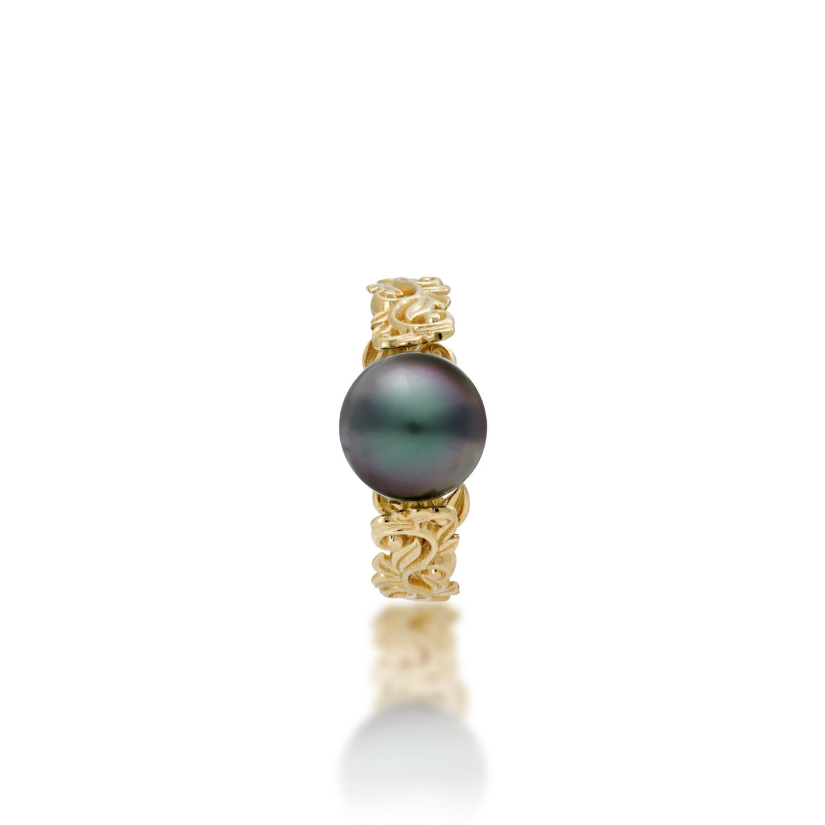 Top view of a 14k Yellow Gold Living Heirloom Ring with intricate hāpuʻu fern and maile leaf scrollwork and Tahitian black pearl at the center, shown on a white background
