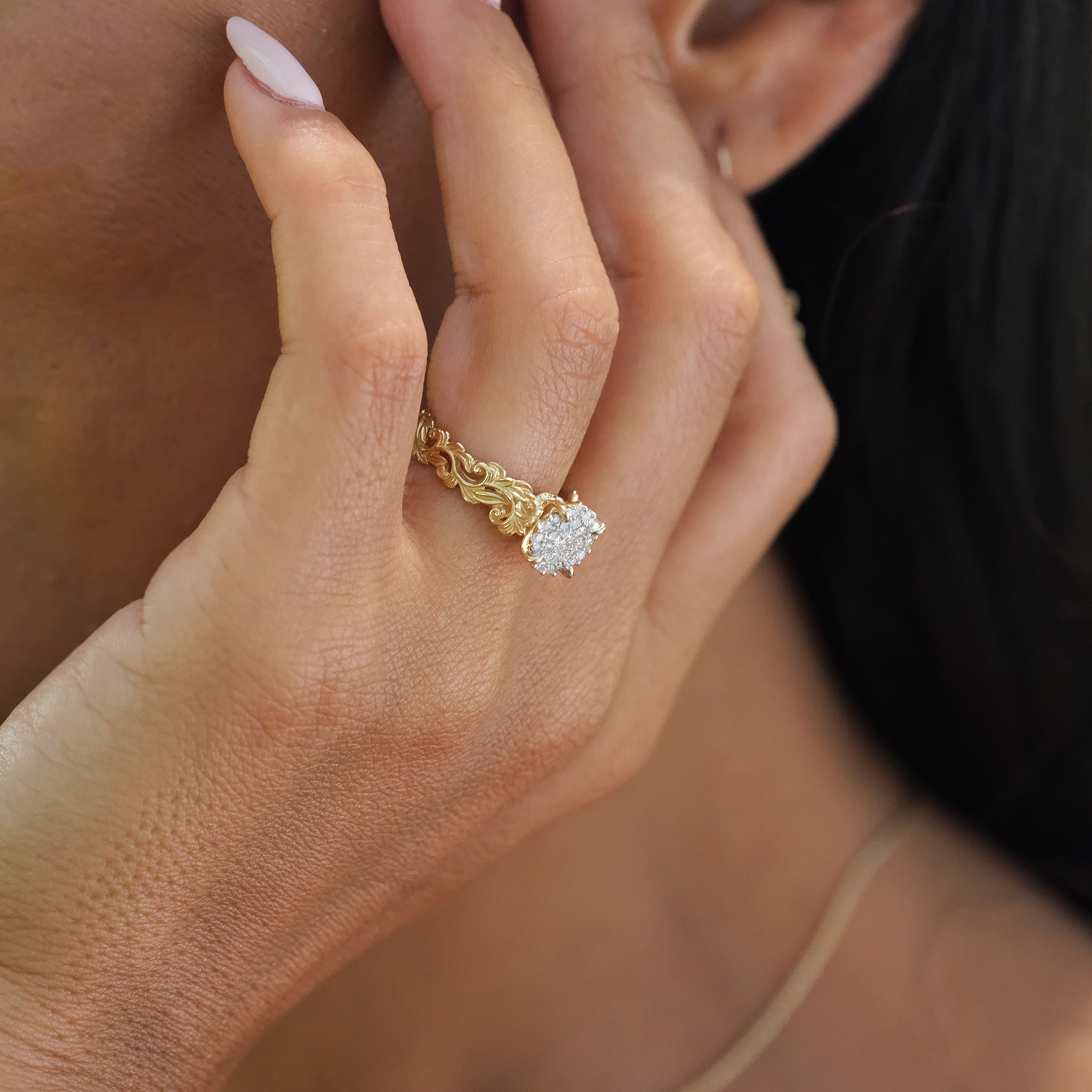 Close up of Living Heirloom Engagement Ring in Gold with Diamonds on a woman's hand