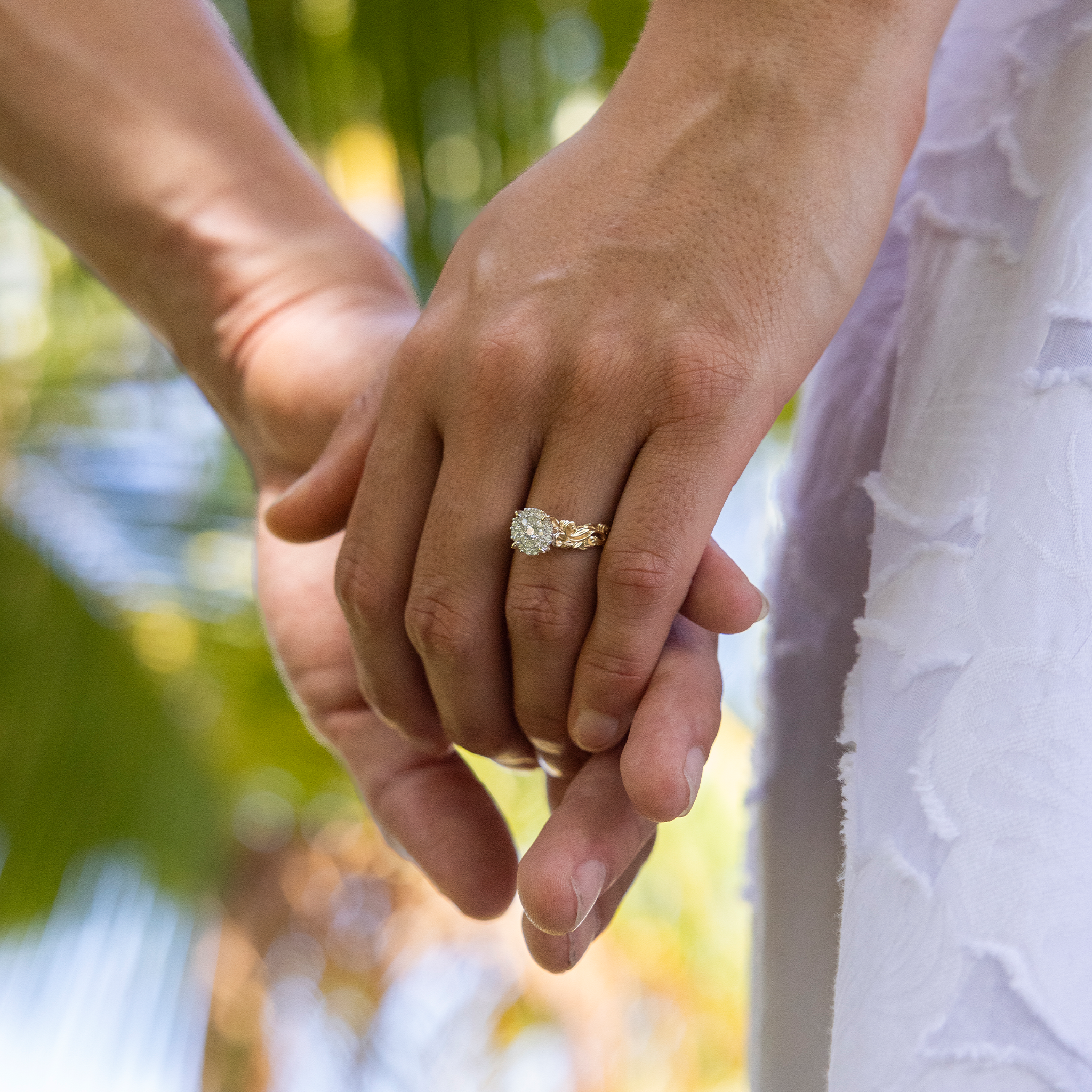 Couple holding hands wearing Living Heirloom Engagement Ring in Gold with Diamonds outdoors