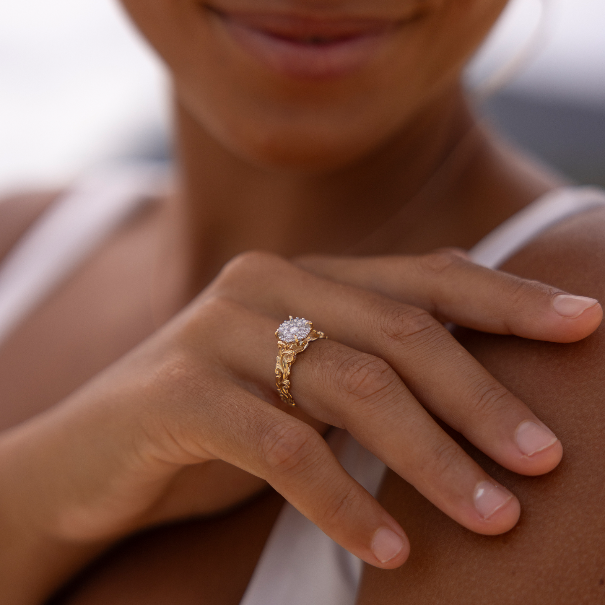 Hand on a shoulder wearing a Living Heirloom Engagement Ring in Gold with Diamonds