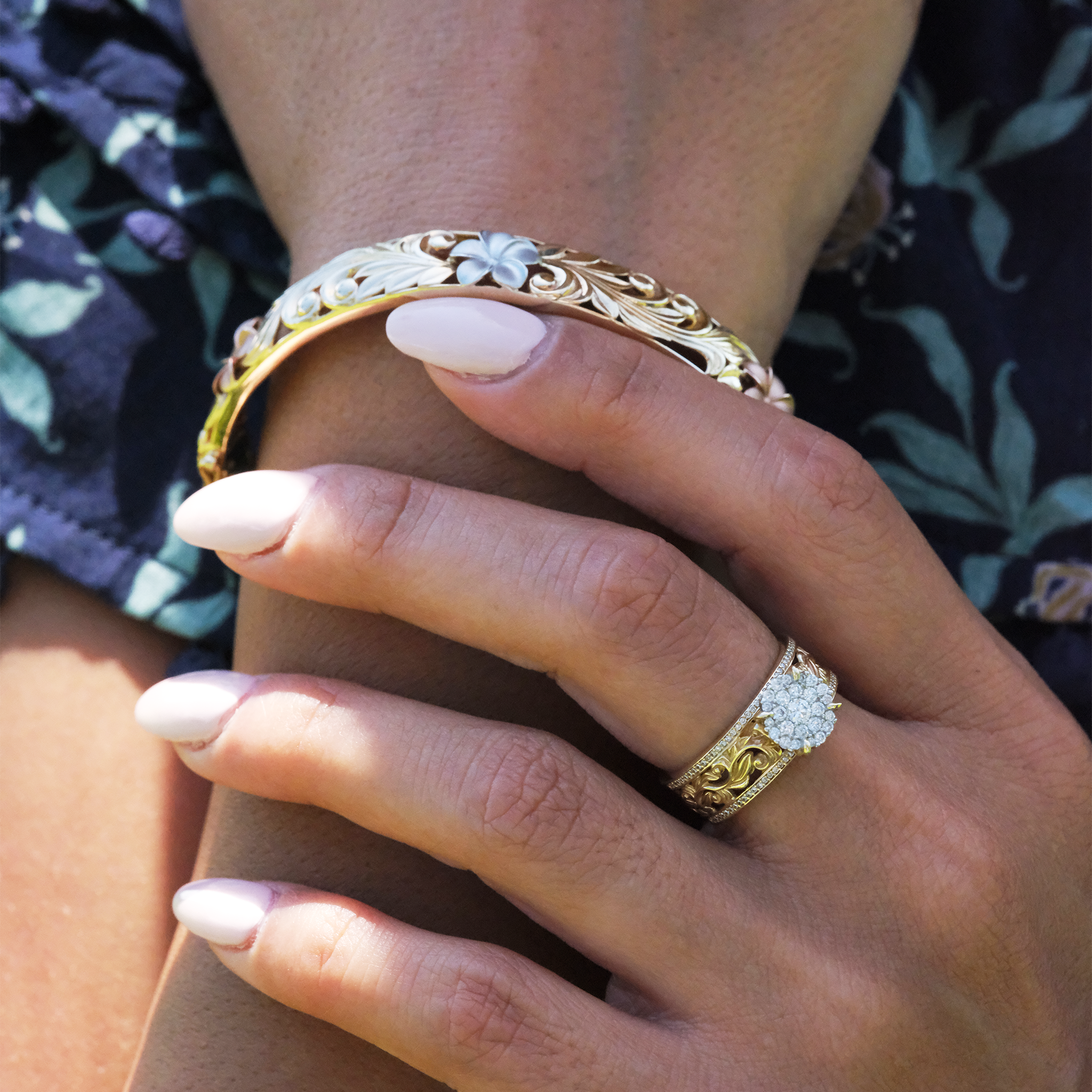 A woman's hand with a Living Heirloom Engagement Ring in Gold with Diamonds and a bracelet