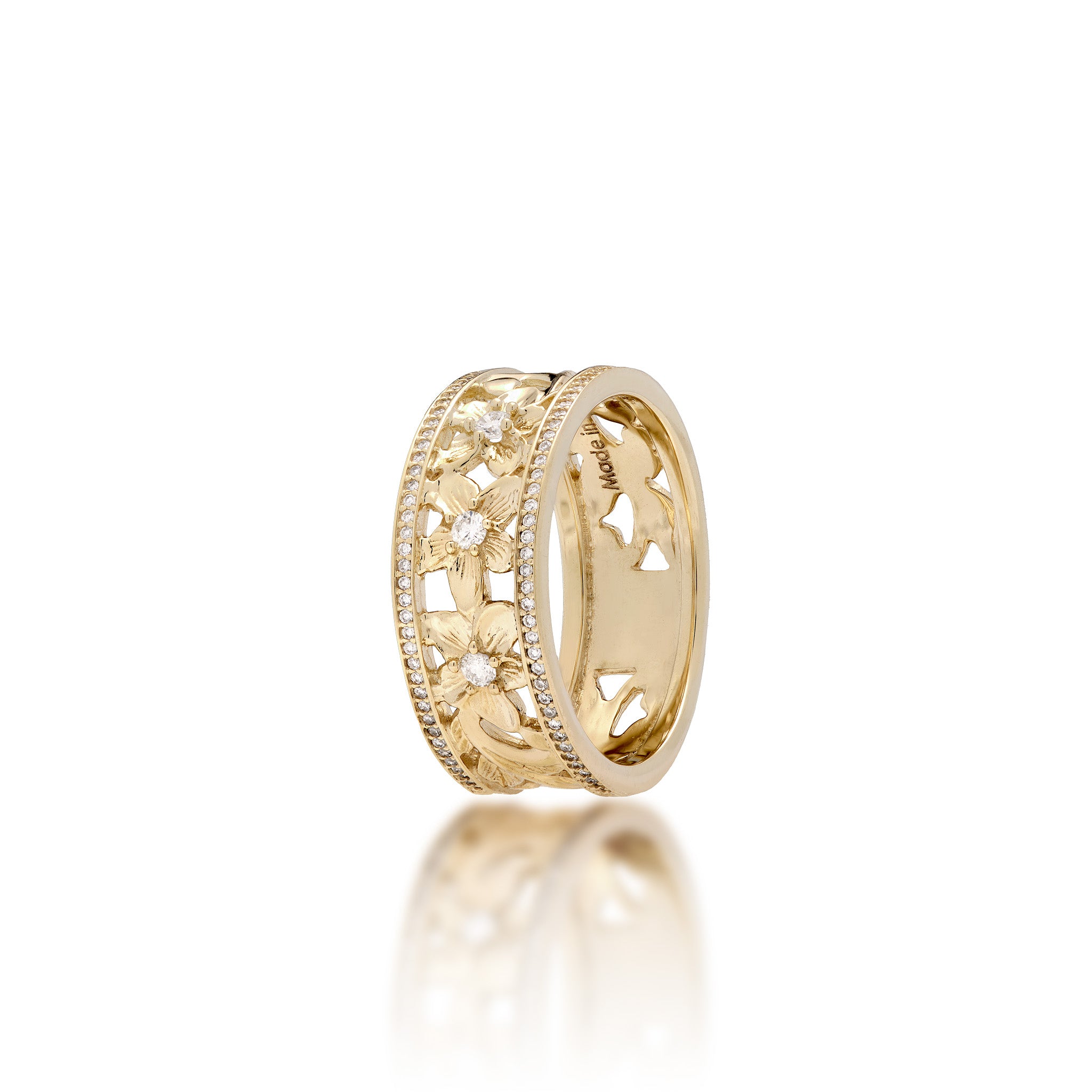 A 14k yellow gold Hawaiian Heirloom ring featuring a row of small pavé-set diamonds on each side of the band and cut-out diamond-accented plumeria flowers at the center, shown on a clean white background with a soft reflection below.