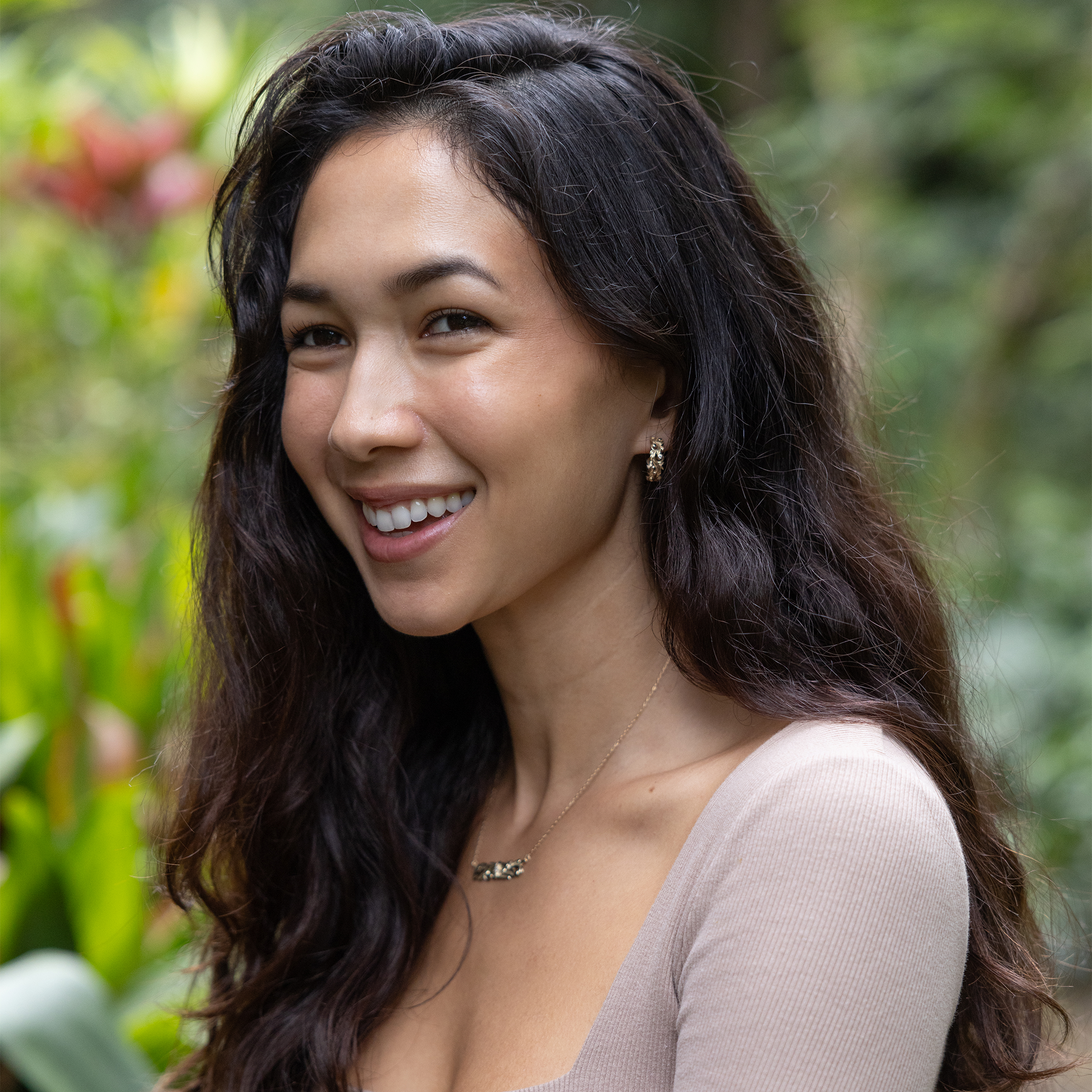 Woman in a garden wearing Living Heirloom Hoop Earrings in Gold with Diamonds