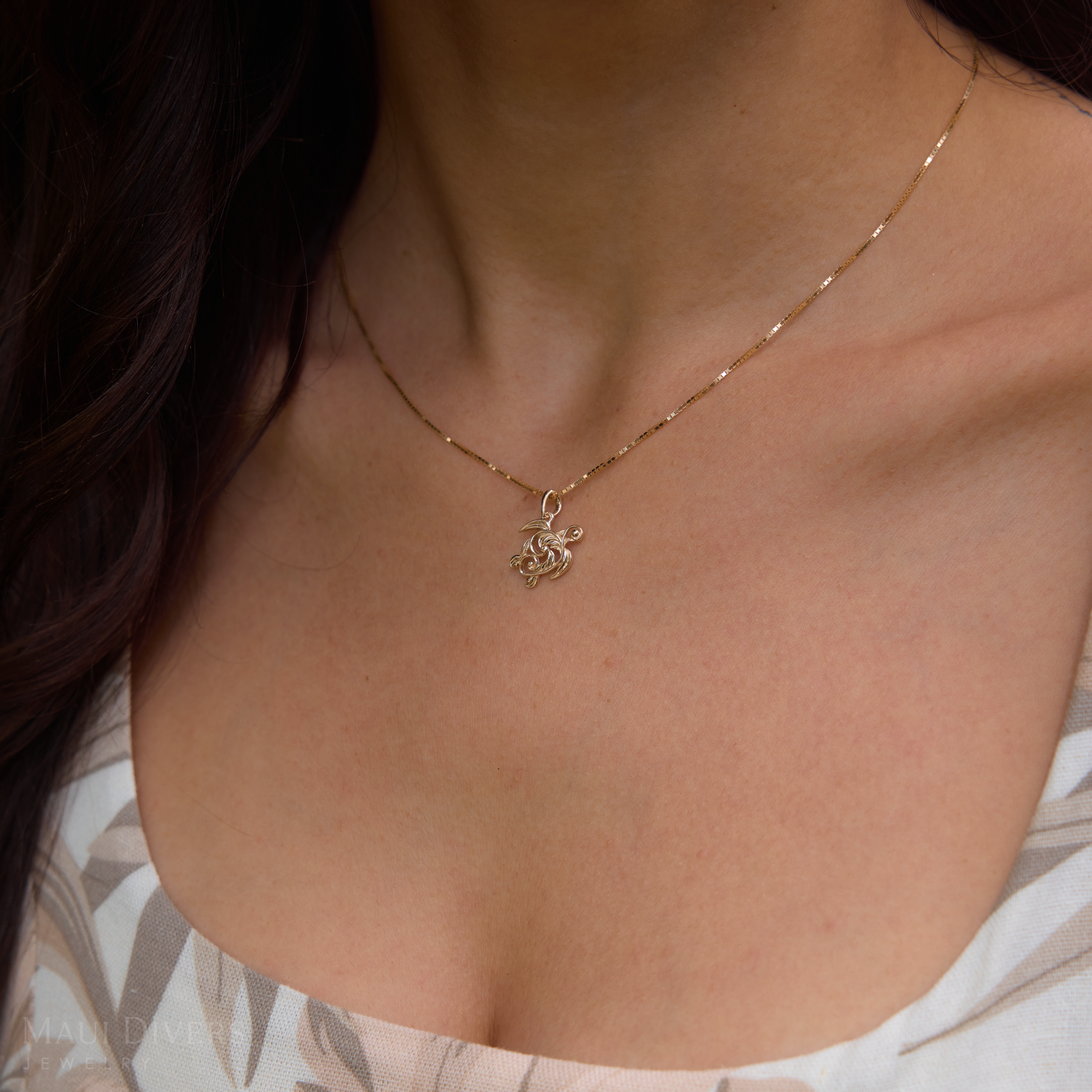 Close up of Living Heirloom Honu Pendant in Gold on a woman's chest
