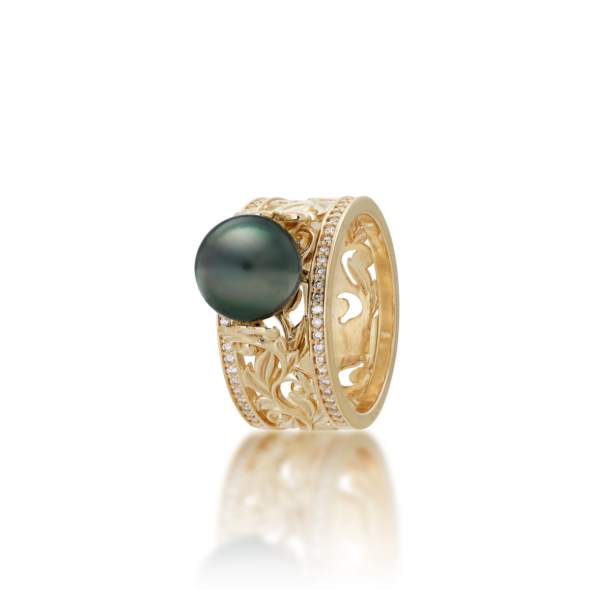 A 14k yellow gold ring with a wide band featuring a row of diamonds on each side and Living Heirloom Collection scrollwork with maile leaves and hāpuʻu ferns that meet a Tahitian black pearl at the crown, shown on a white background