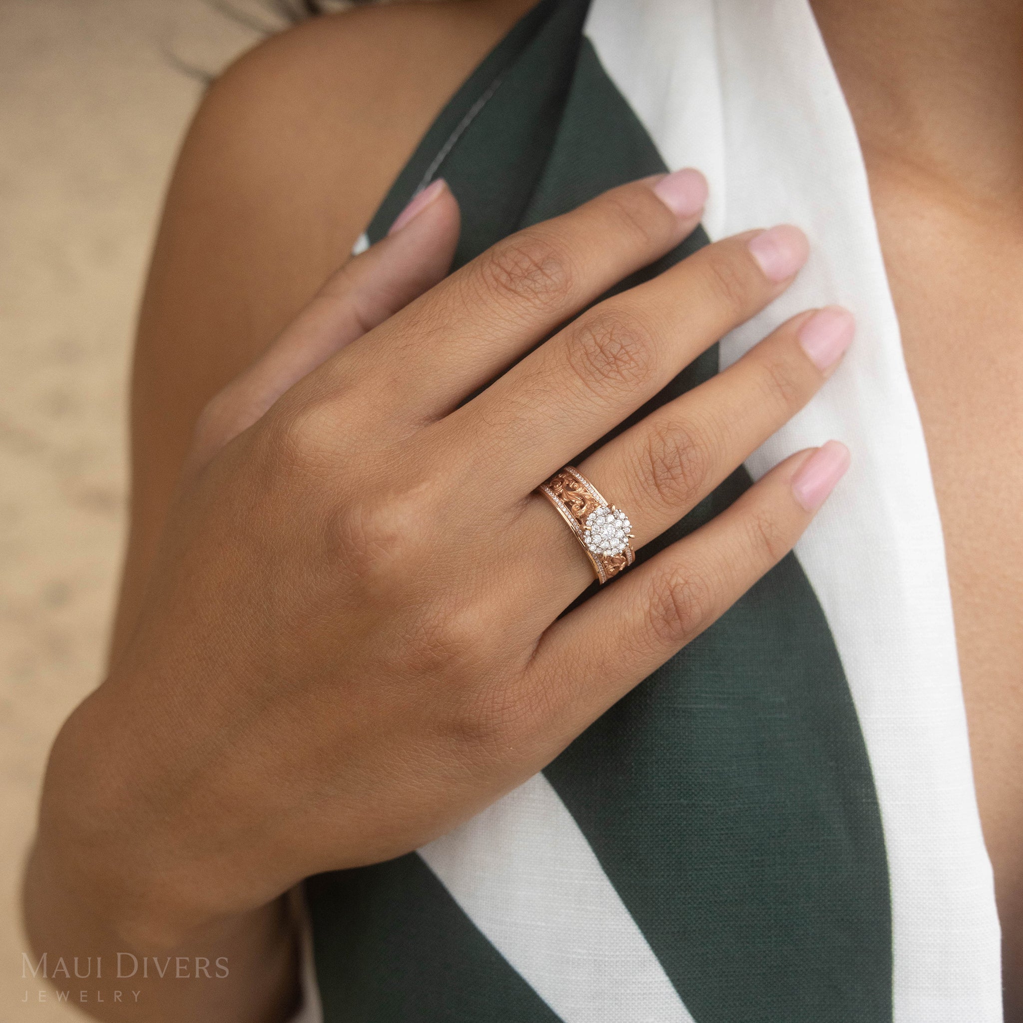 Close-up of a hand wearing a Living Heirloom Engagement Ring in Rose Gold with Diamonds resting on shoulder