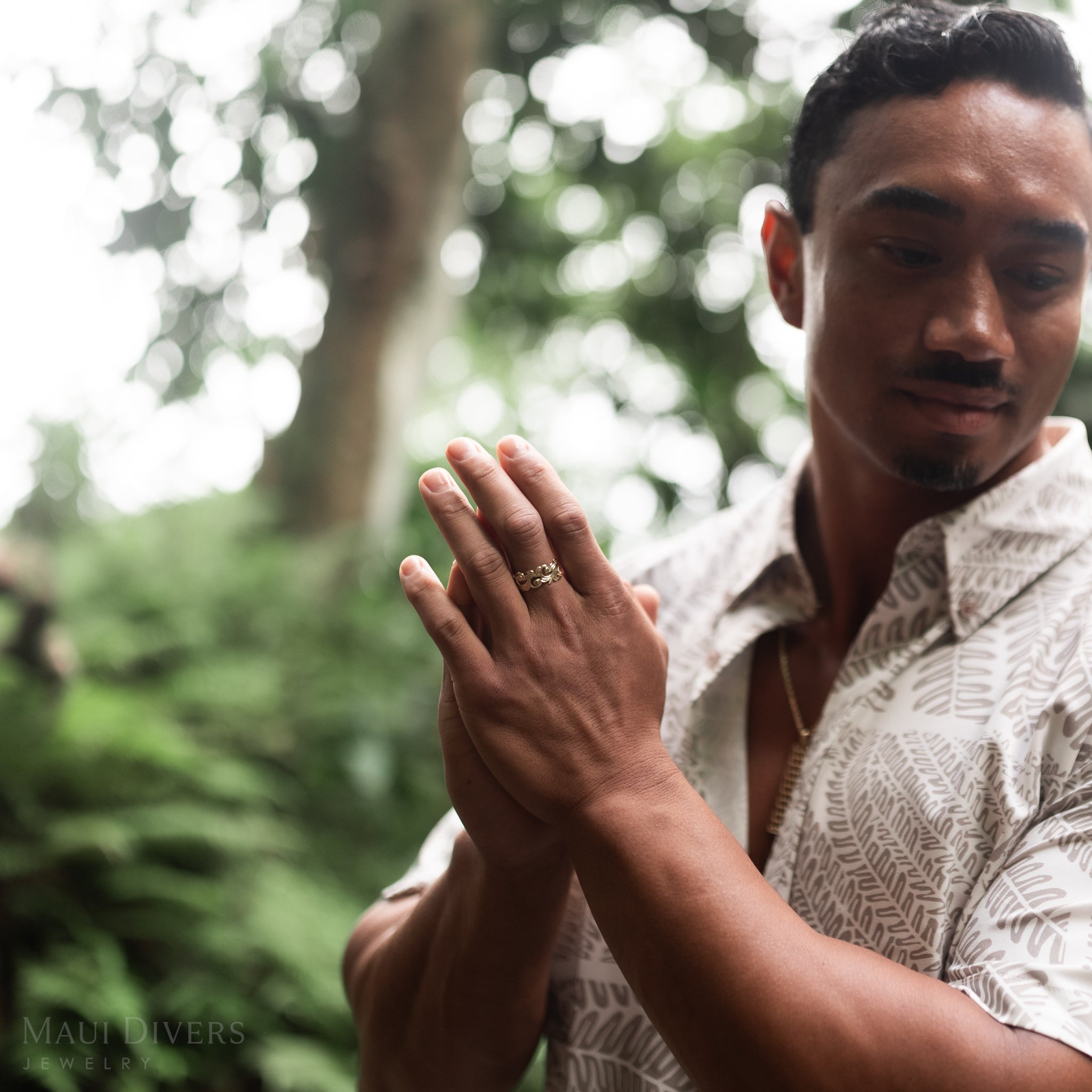 Man in a forest wearing a Living Heirloom Ring in Gold with Diamonds