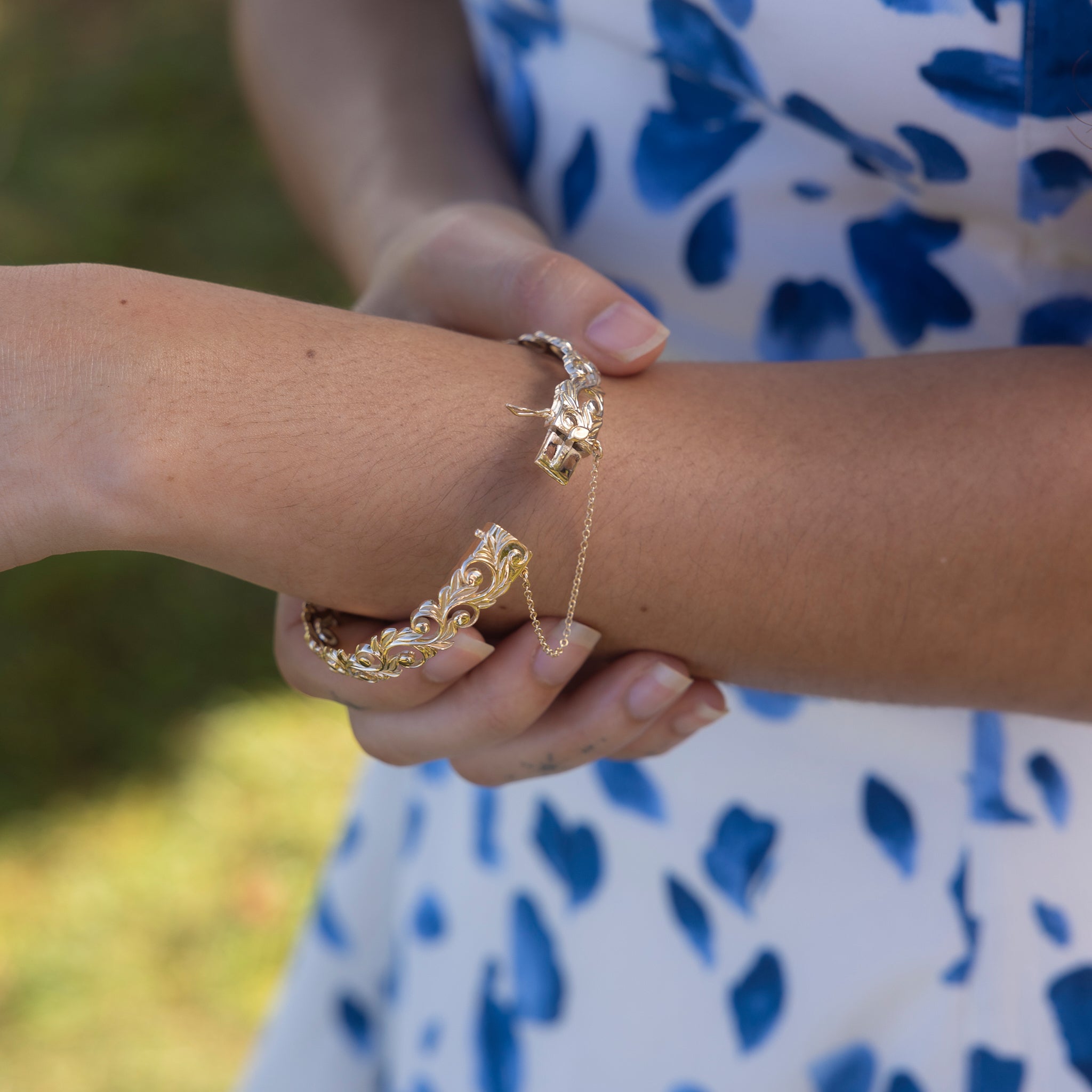Person wearing a Living Heirloom Hinge Bracelet in 14k Yellow Gold, showing the open clasp