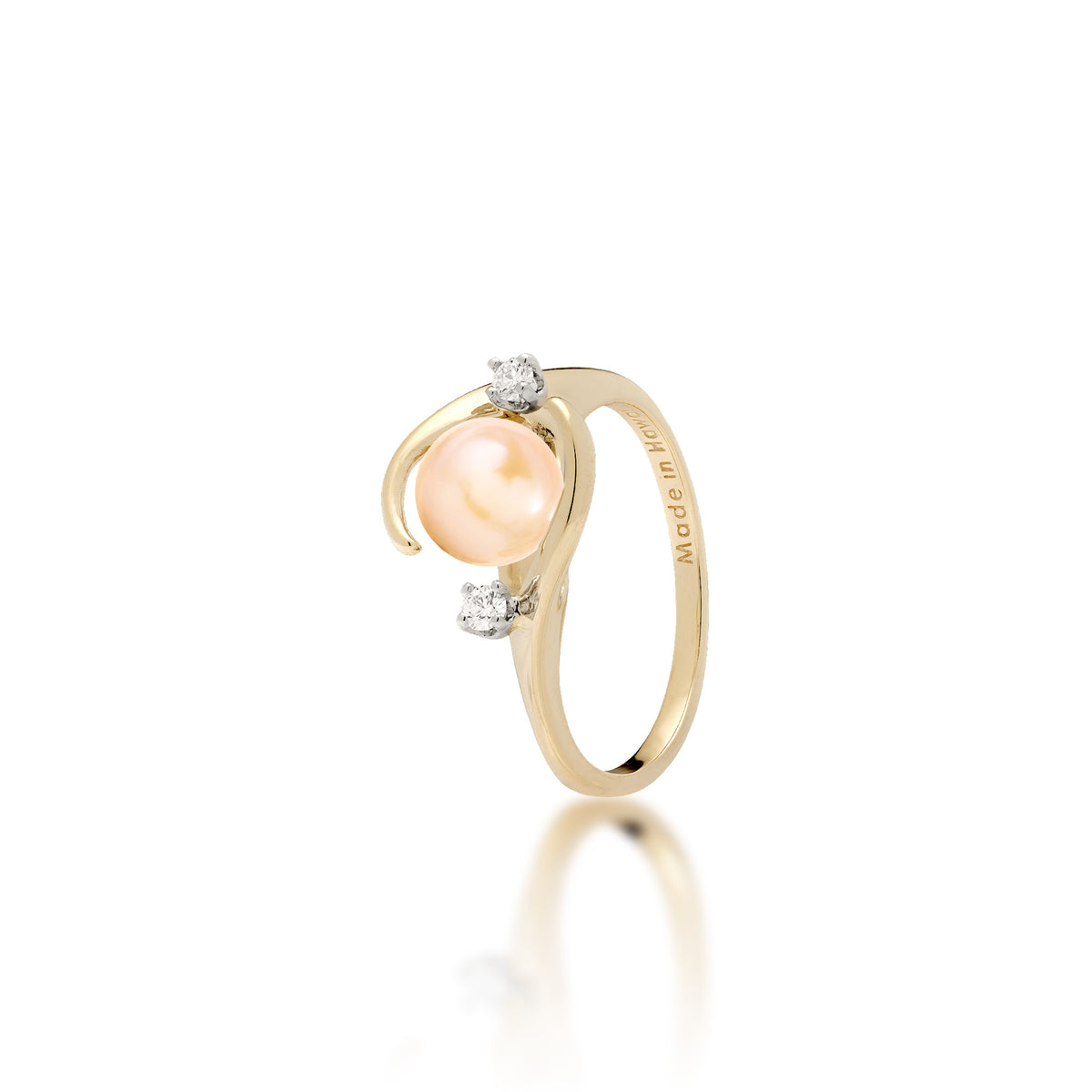 A 14k yellow gold ring with a high-polish finish featuring a round peach freshwater pearl accented by two small diamonds, shown on a clean white background with a soft reflection.