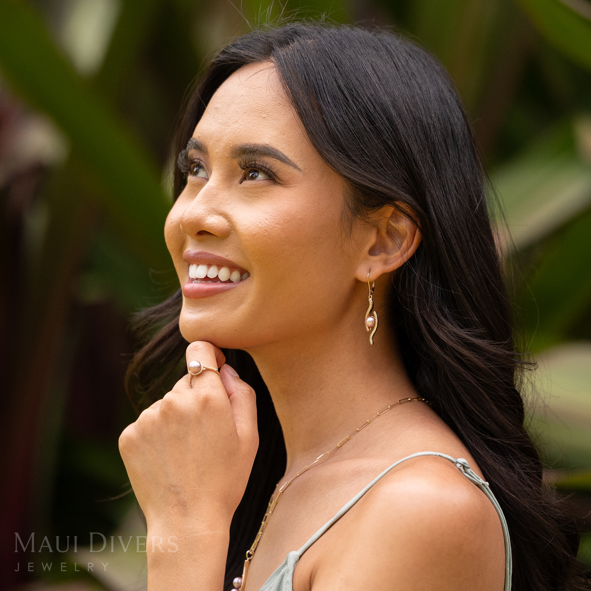 Woman in a garden wearing a Pick A Pearl Halo Ring in Gold with Diamonds and Lavender Pearl