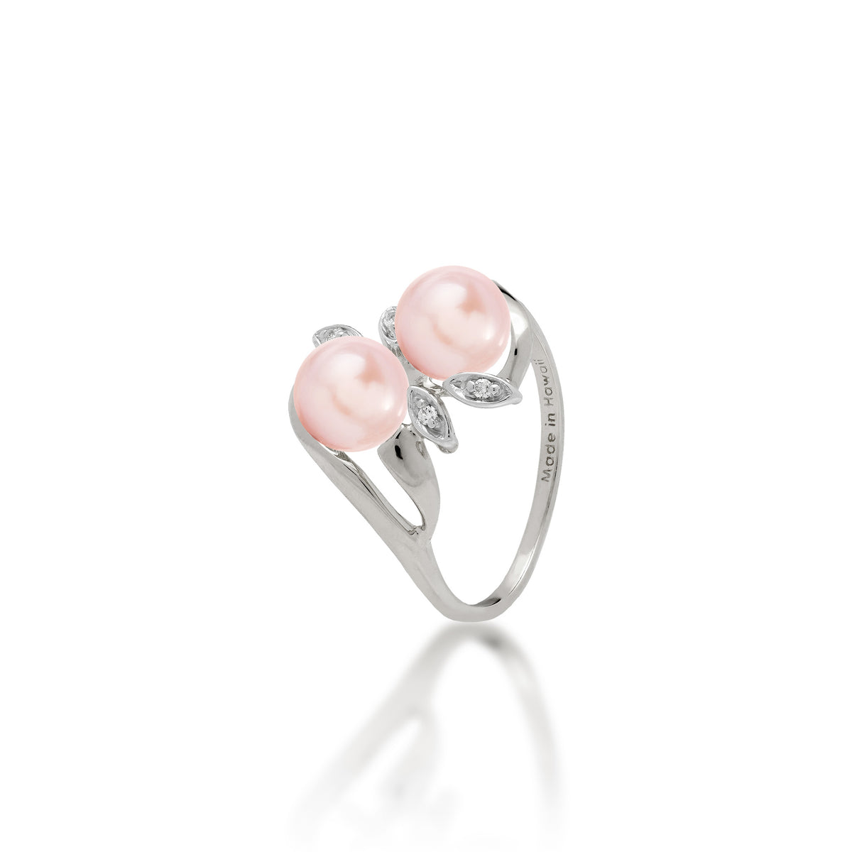 A 14k white gold ring with two pink freshwater pearls and two diamond accent maile leaves on each side, shown on white background