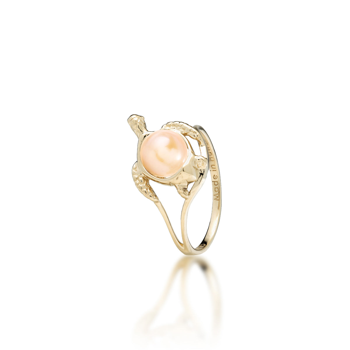 A 14k yellow gold sea turtle ring with a peach freshwater pearl as its shell, shown on a white background