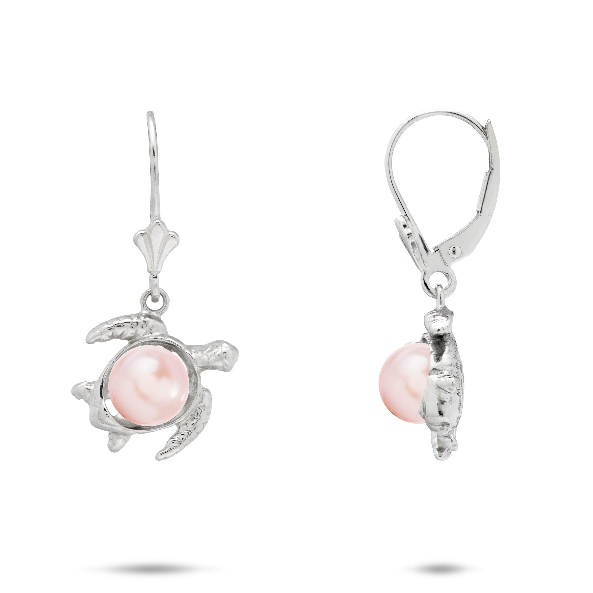 A pair of sterling silver earrings featuring a Hawaiian green sea turtle-shaped setting holding a round, pink freshwater pearl, shown against a plain white background.