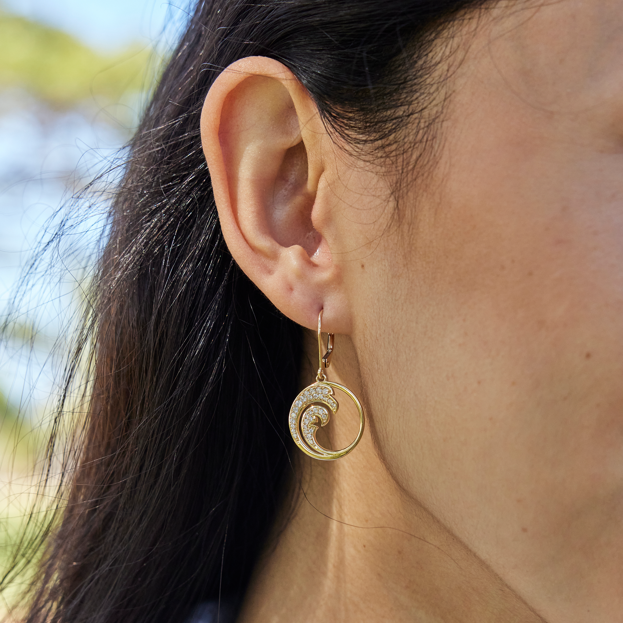 Close up of Nalu Earrings in Gold with Diamonds on Model