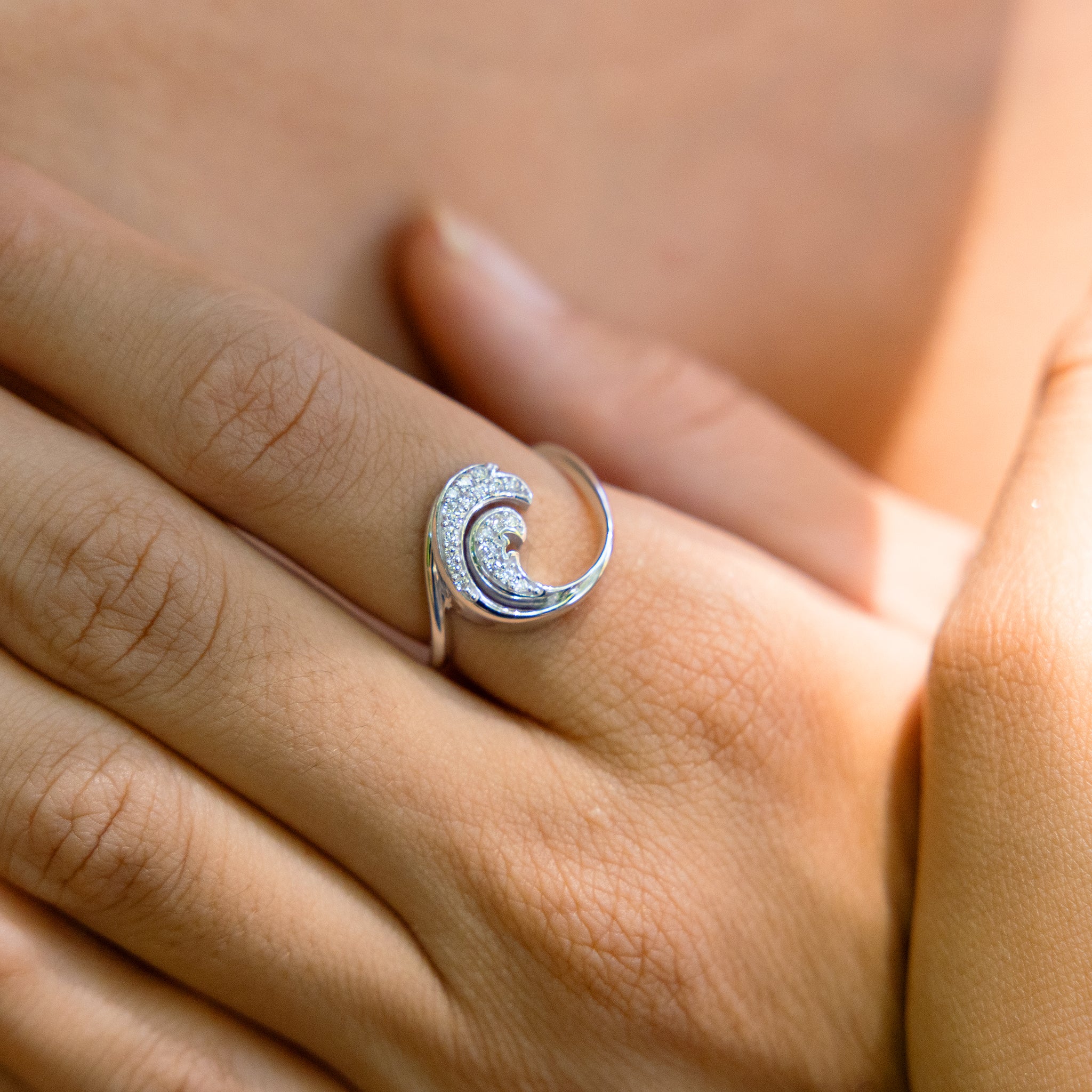 Close up of Nalu Ring in White Gold with Diamonds - 15mm on hand