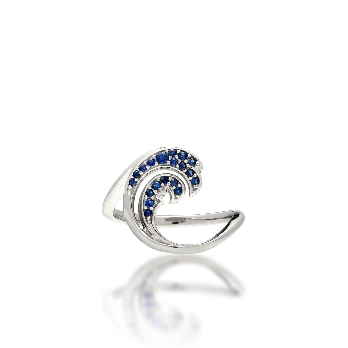 A Nalu (Wave) Ring in high-olish 14k white gold with a blue sapphire double-wave design, shown on a white background