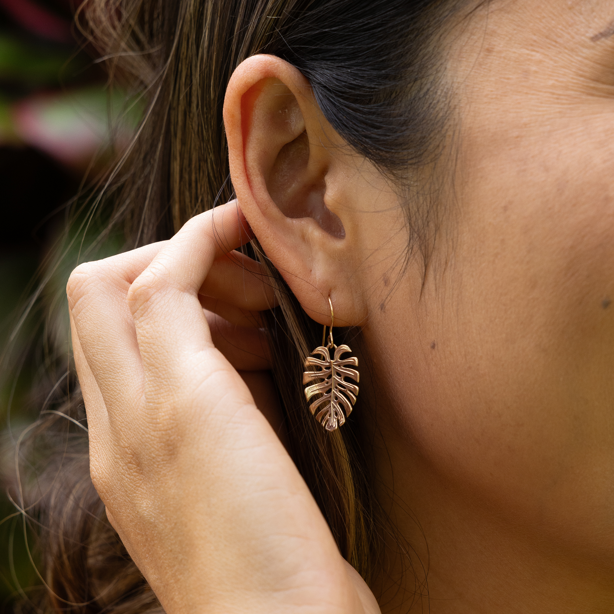 Clsoe up of 23mm Monstera Earrings in Gold on ear
