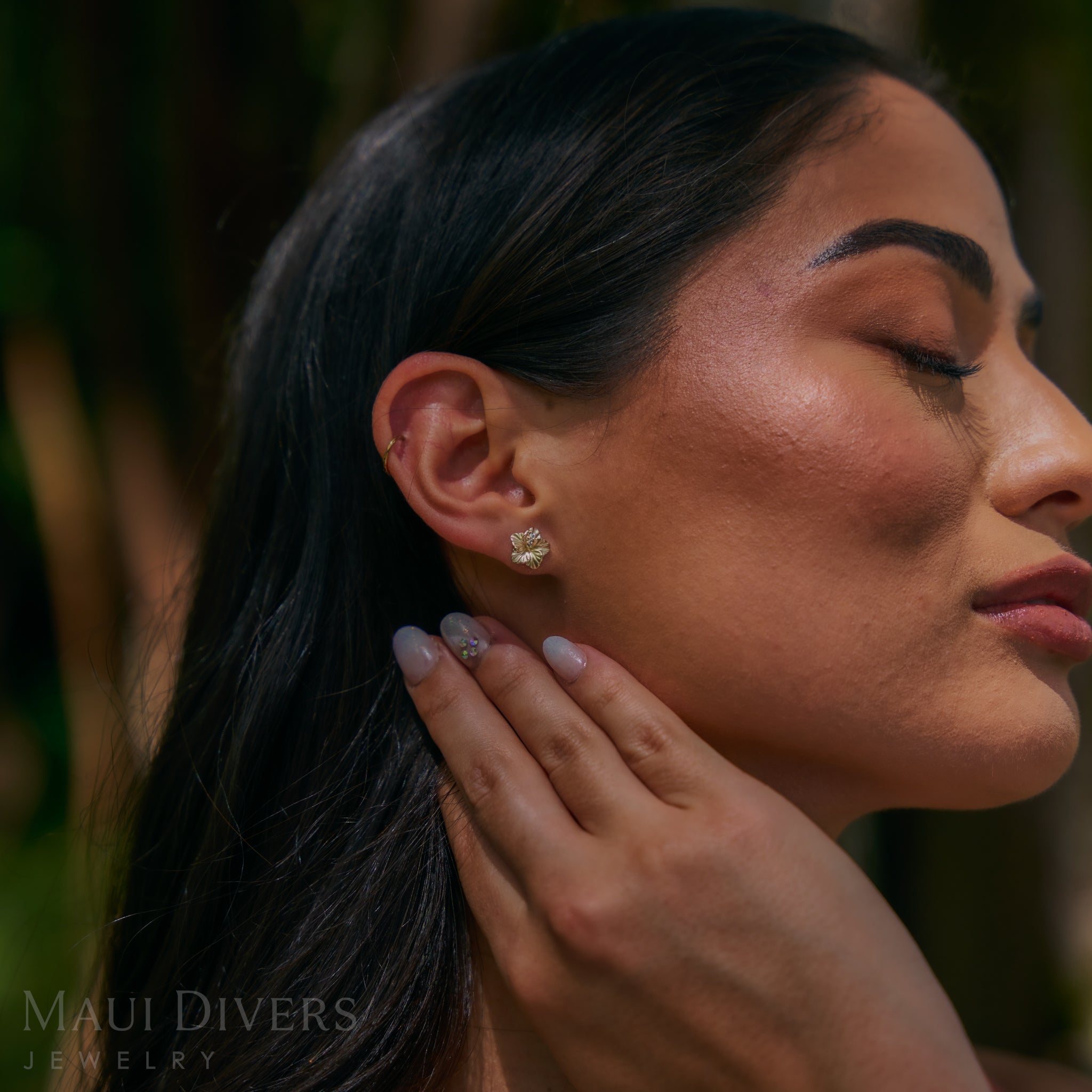 Close up of a woman wearing 9.5mm Diamond Hibiscus Earrings in 14k Yellow Gold
