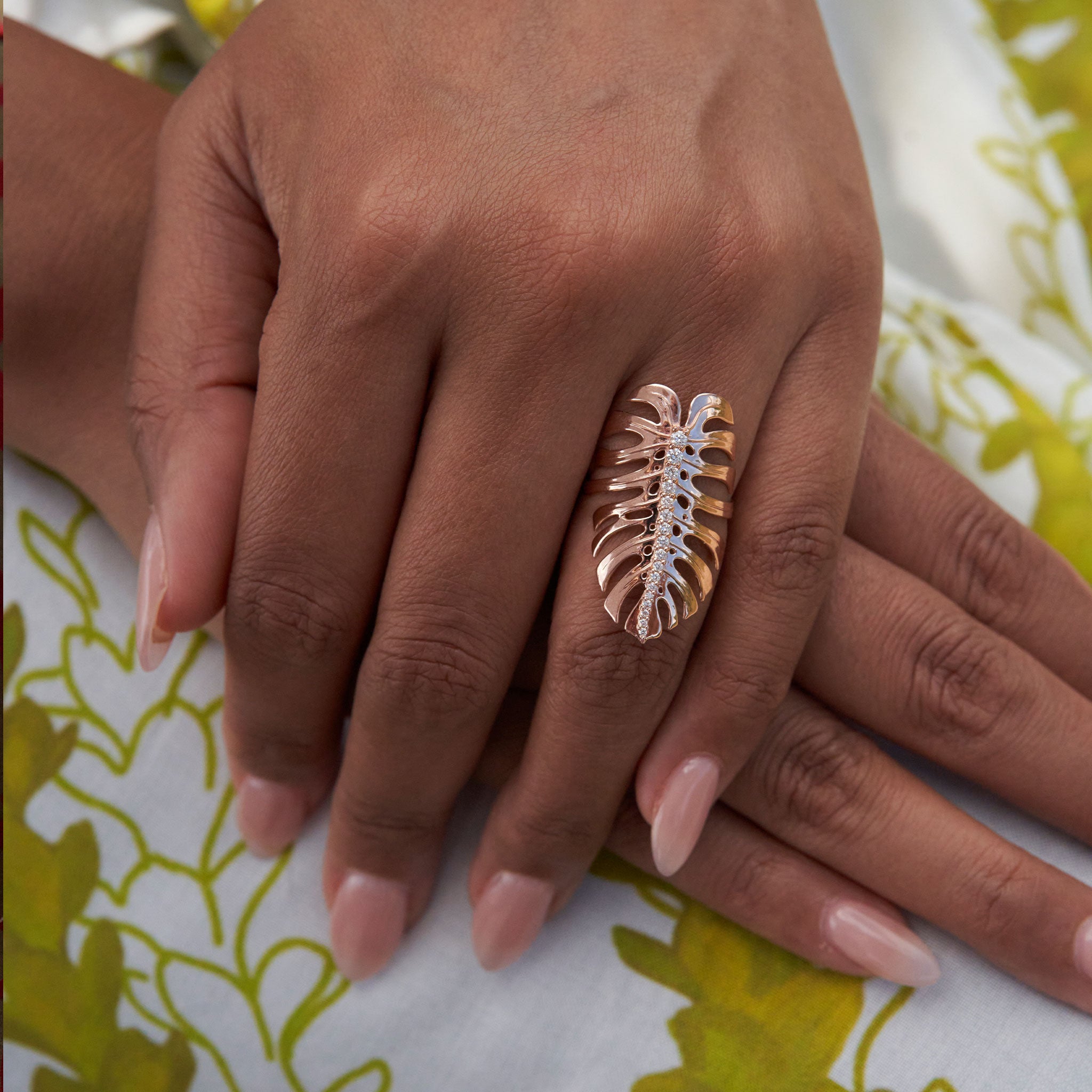 Close up of 32mm Monstera Ring in Rose Gold with Diamonds on a woman's hands
