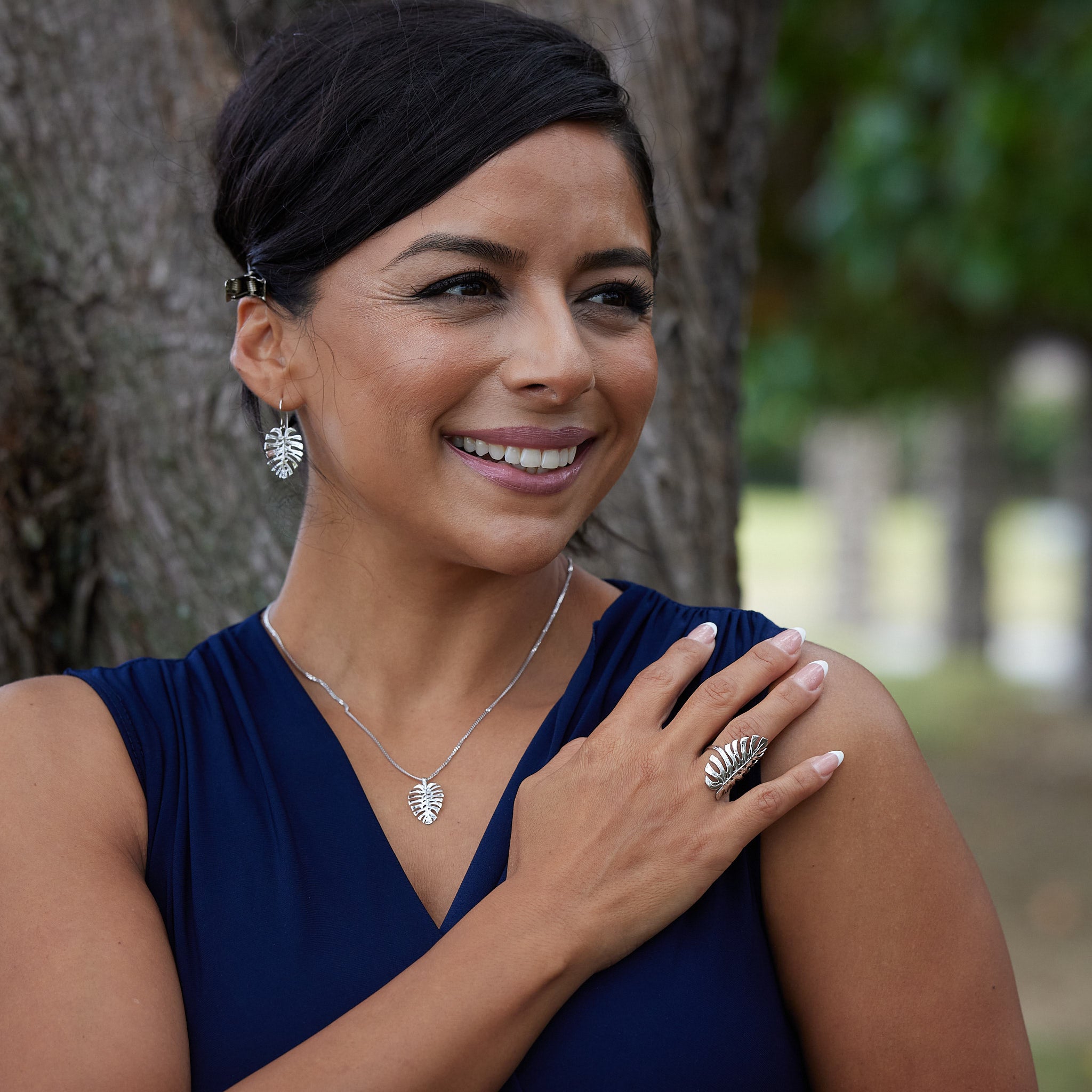 A woman wearing a Monstera Pendant in White Gold - 20mm - Maui Divers Jewelry