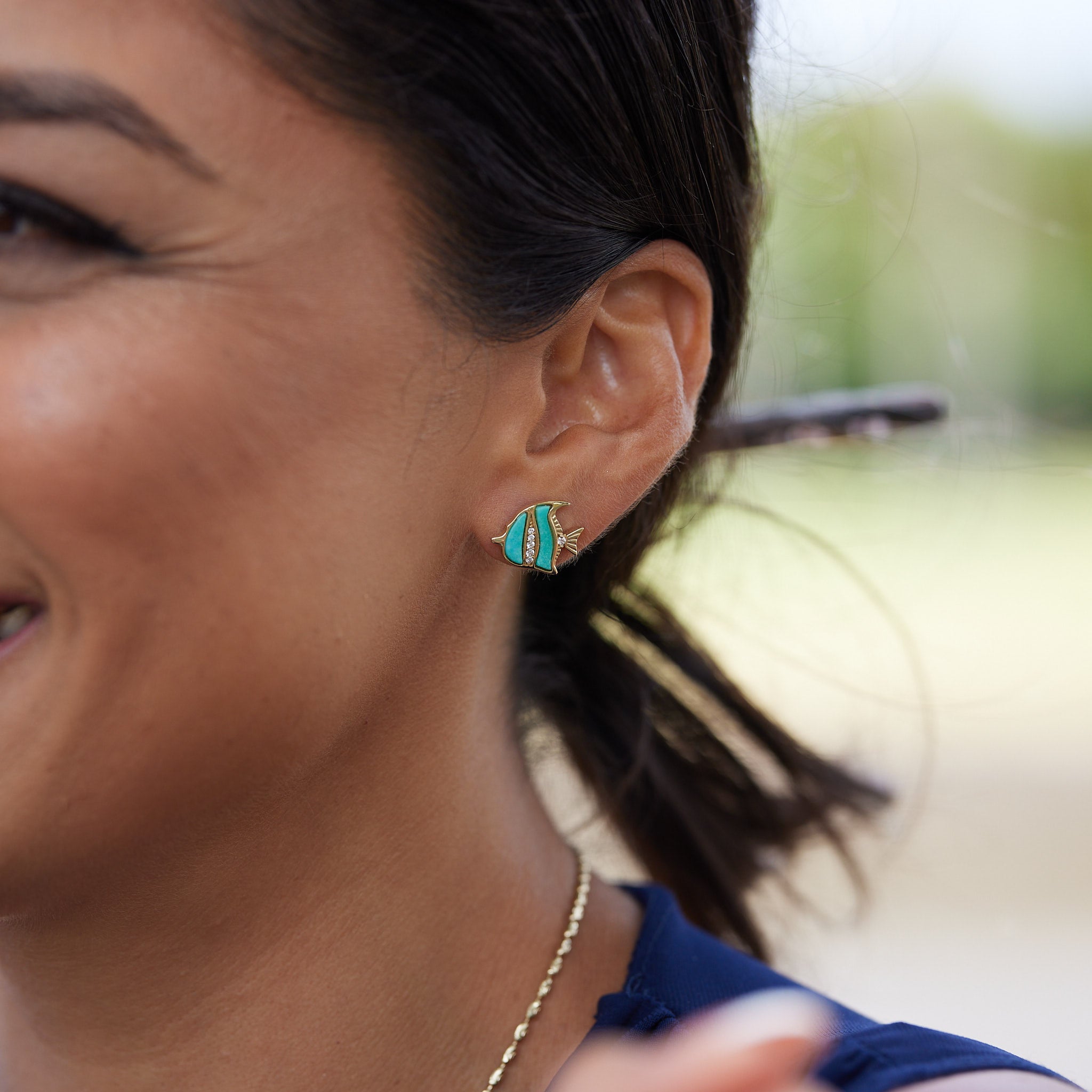 A woman's ear with Sealife Angelfish Turquoise Earrings in Gold with Diamonds - 12mm - Maui Divers Jewelry