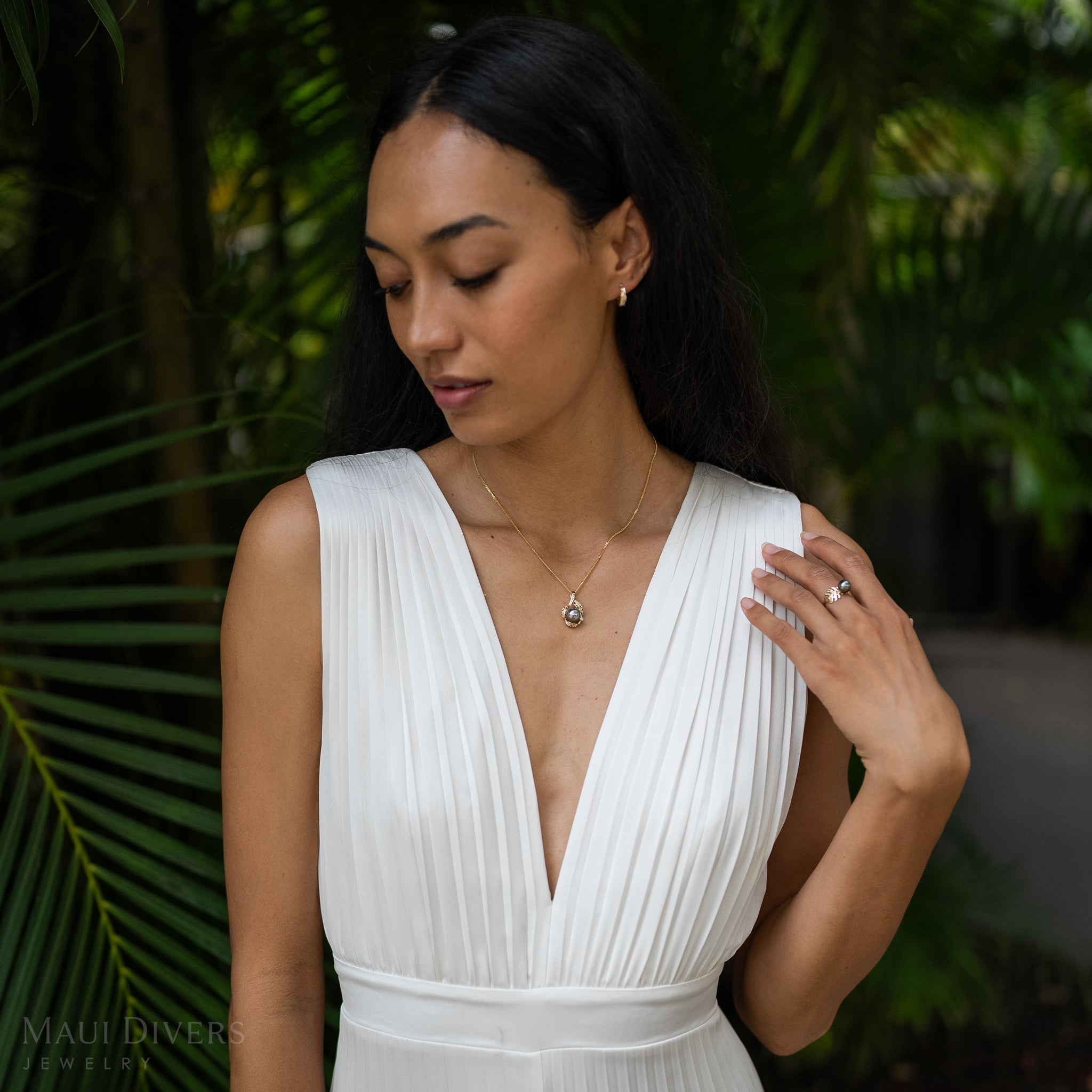 Model Wearing Maile Tahitian Black Pearl Pendant in Gold with Diamonds in white dress