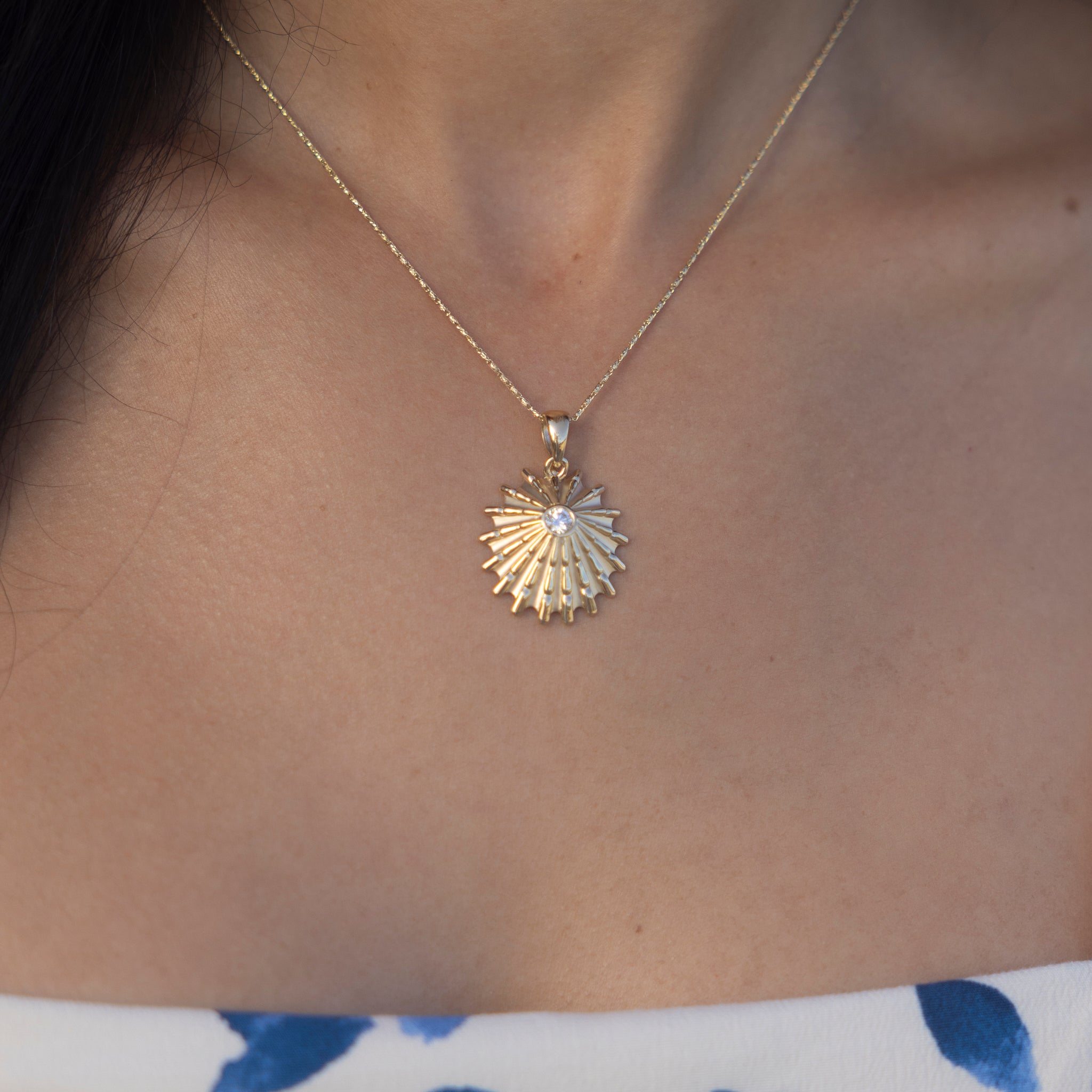 Close up of a woman wearing an ʻOpihi Pendant in Gold with Lab Grown Diamond