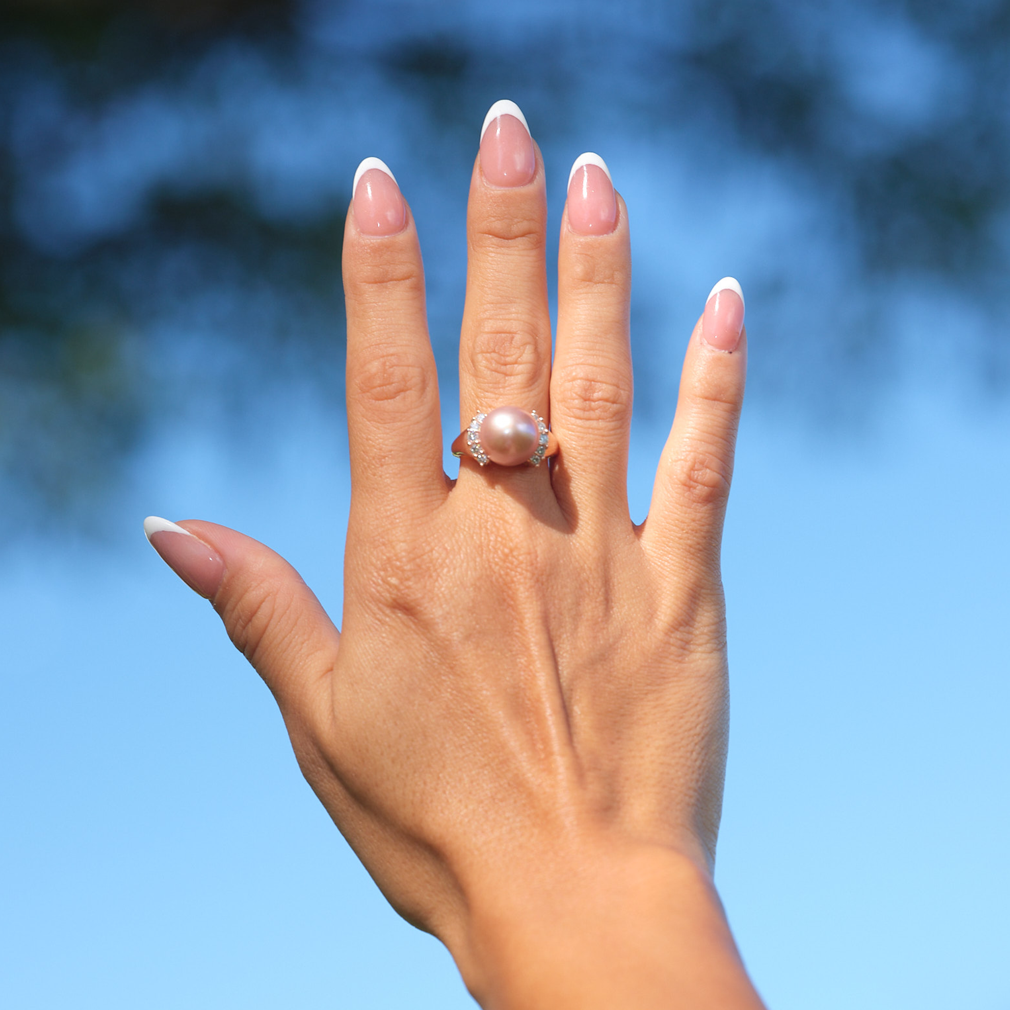 A woman's hand wearing a Lilac Freshwater Pearl Ring with Diamonds in Rose Gold (12-13mm)-Maui Divers Jewelry